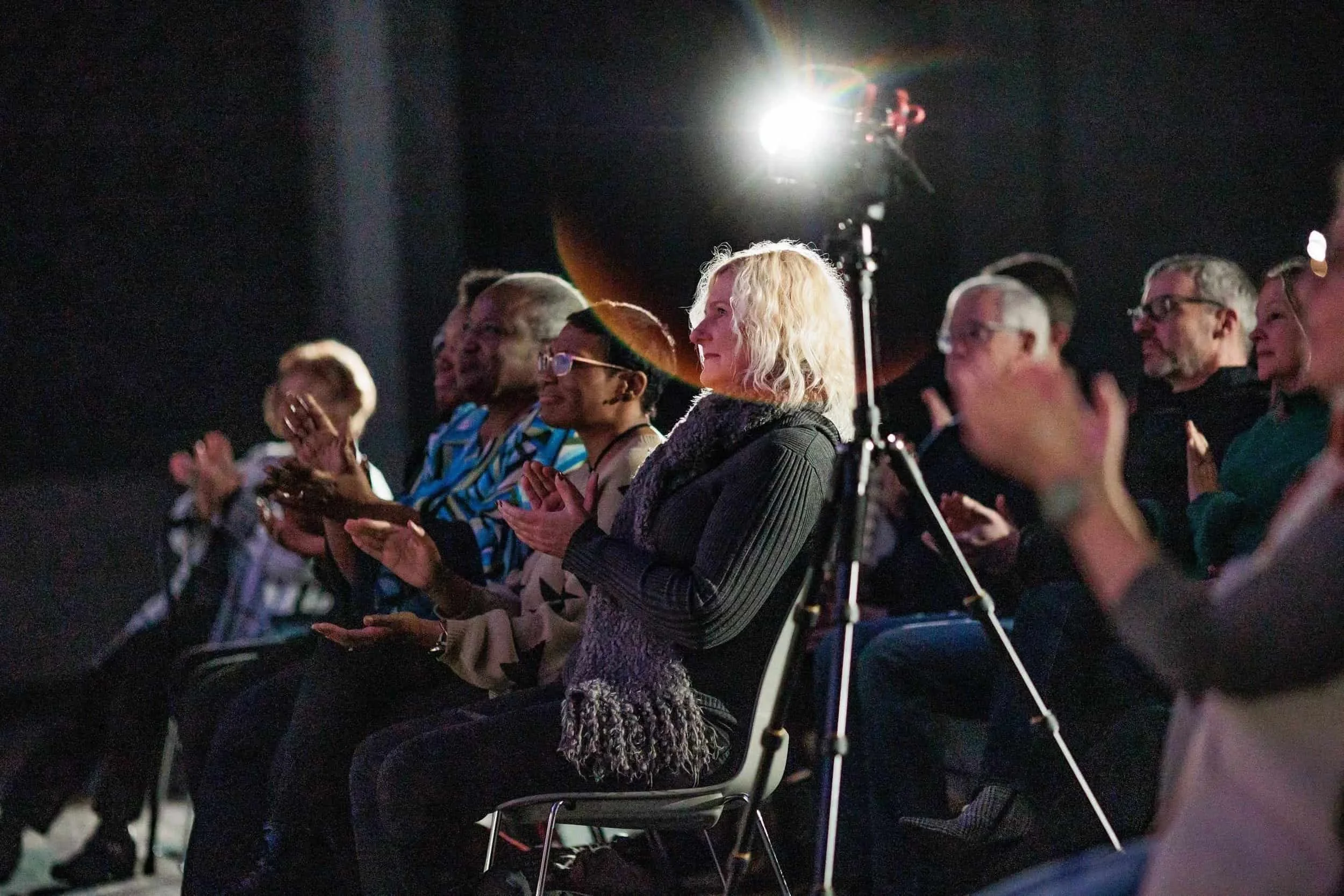 Jim Perona performing under stage lights at a keynote concert
