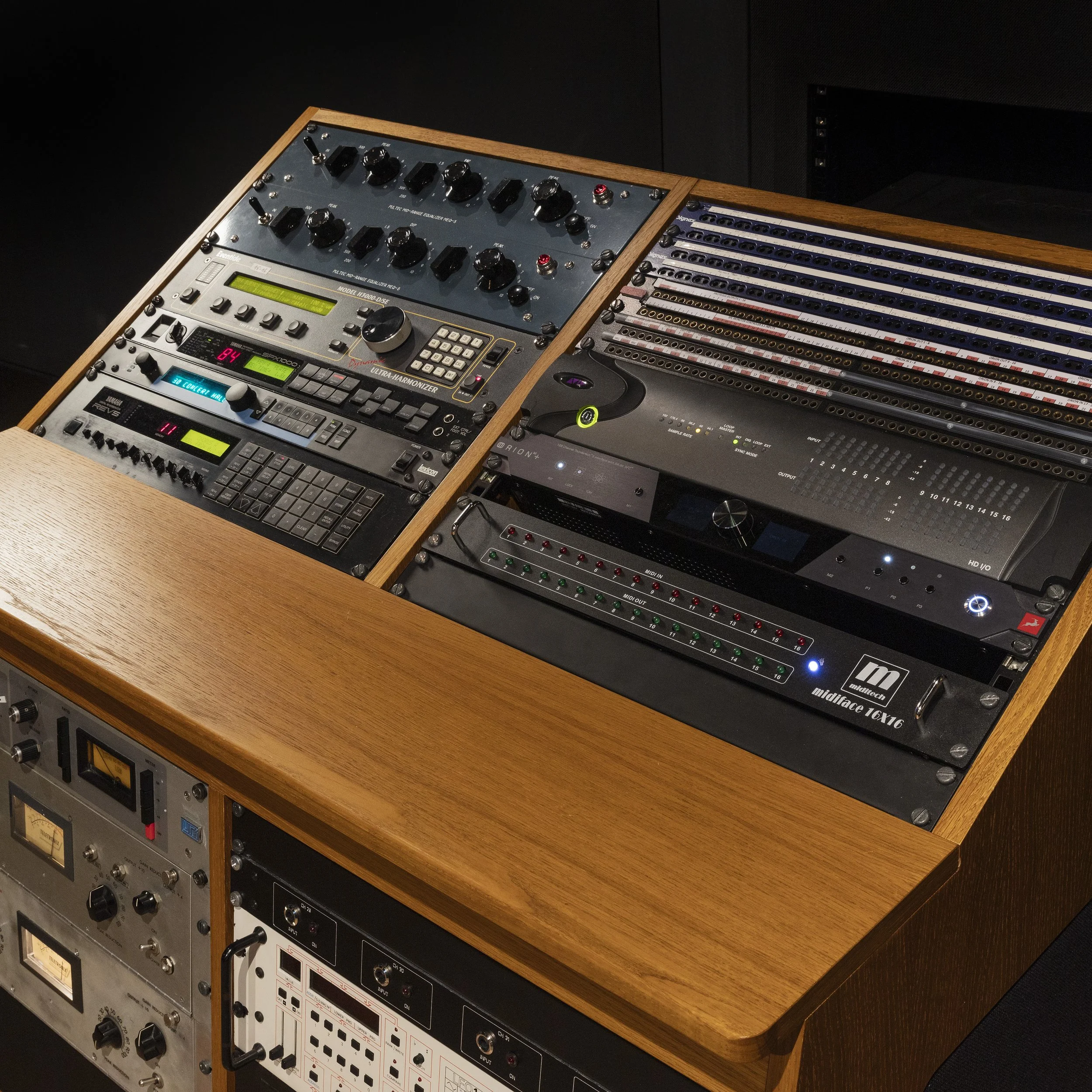 Une console de mixage audio avec divers équipements et câbles.