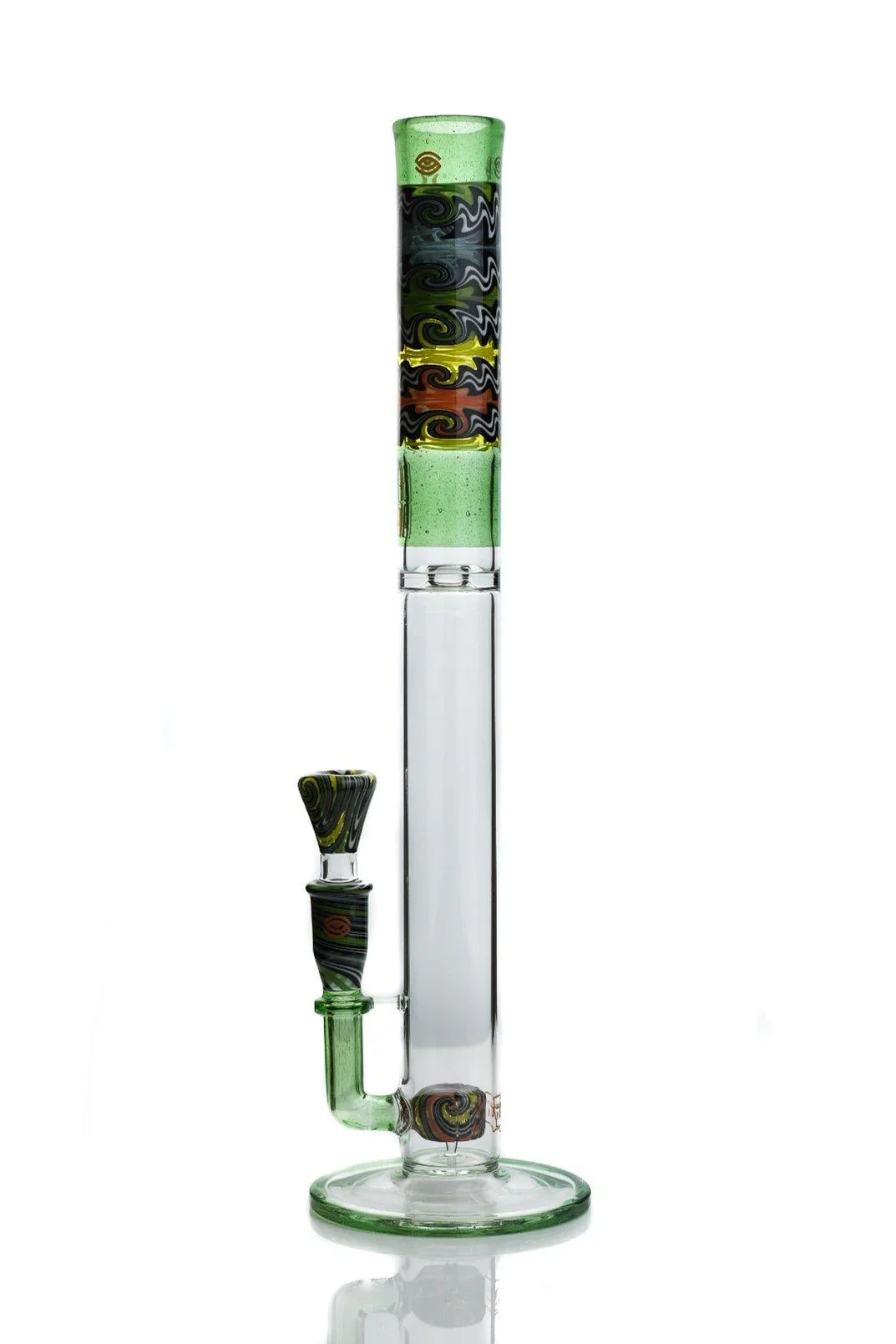A colorful glass bong with a tall, vertical tube, decorated with swirls of black, yellow, green, and red, and a separate bowl piece placed beside it.
