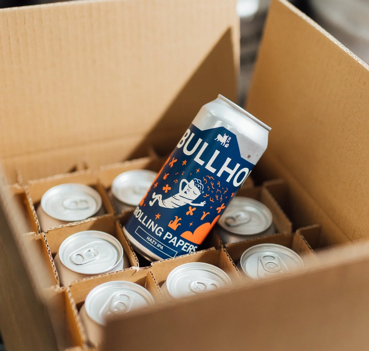 A can of Bullhorn Hazy IPA inside a cardboard box with other cans.