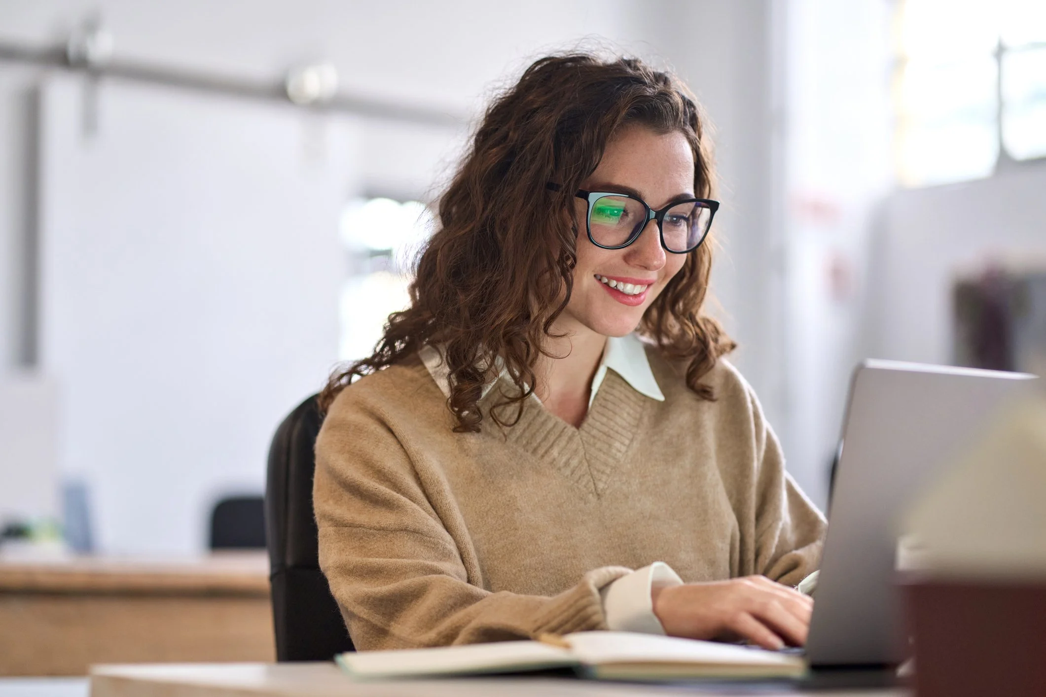 Happy Woman using her laptop