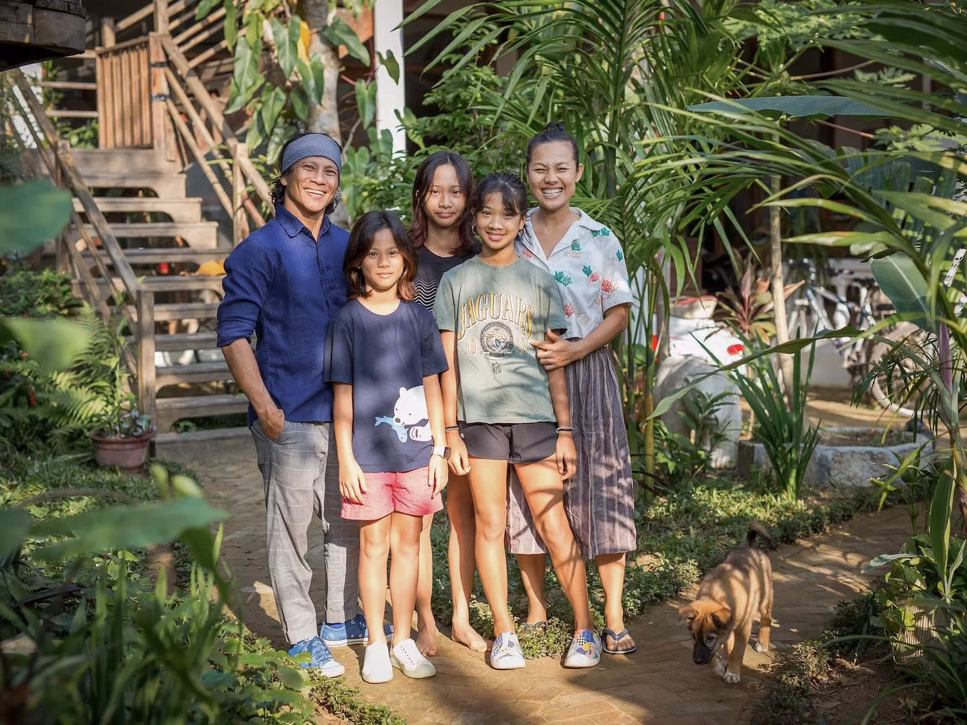 Chef Duc, his wife Ly, and their family together outside their home in Hoi An