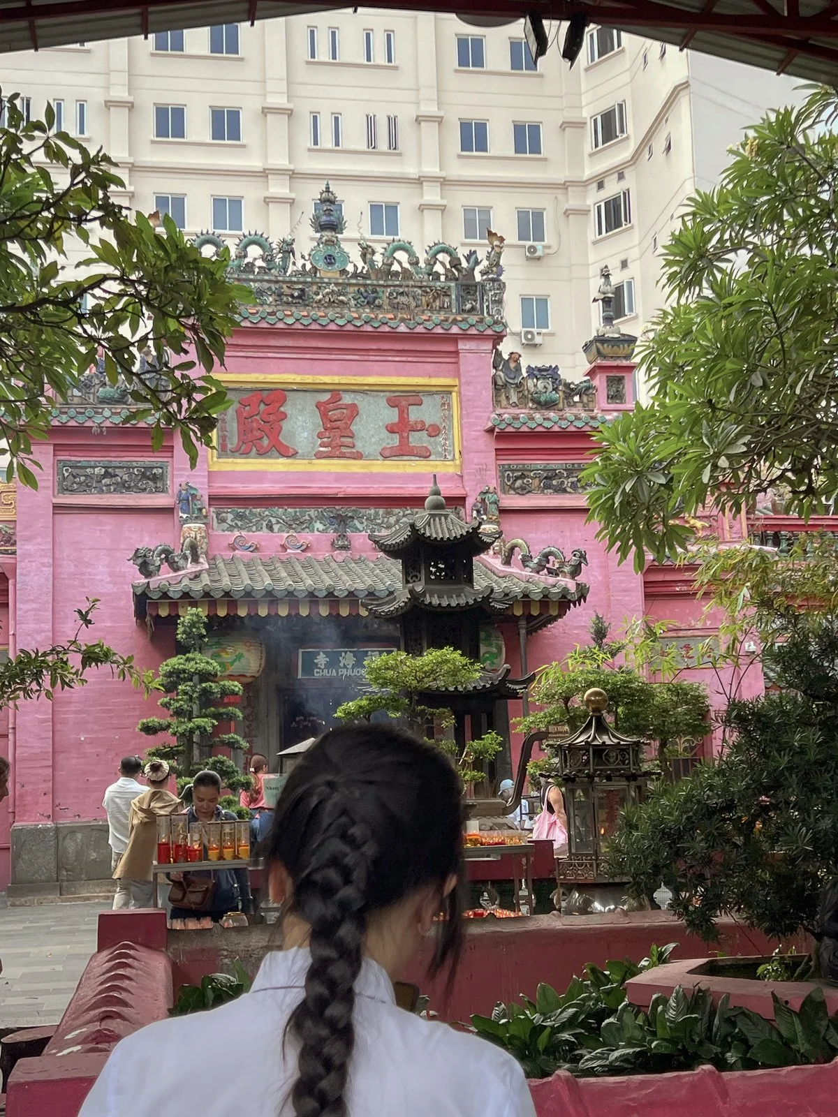Visitor bows before the ornate Jade Emperor Pagoda in Ho Chi Minh City,