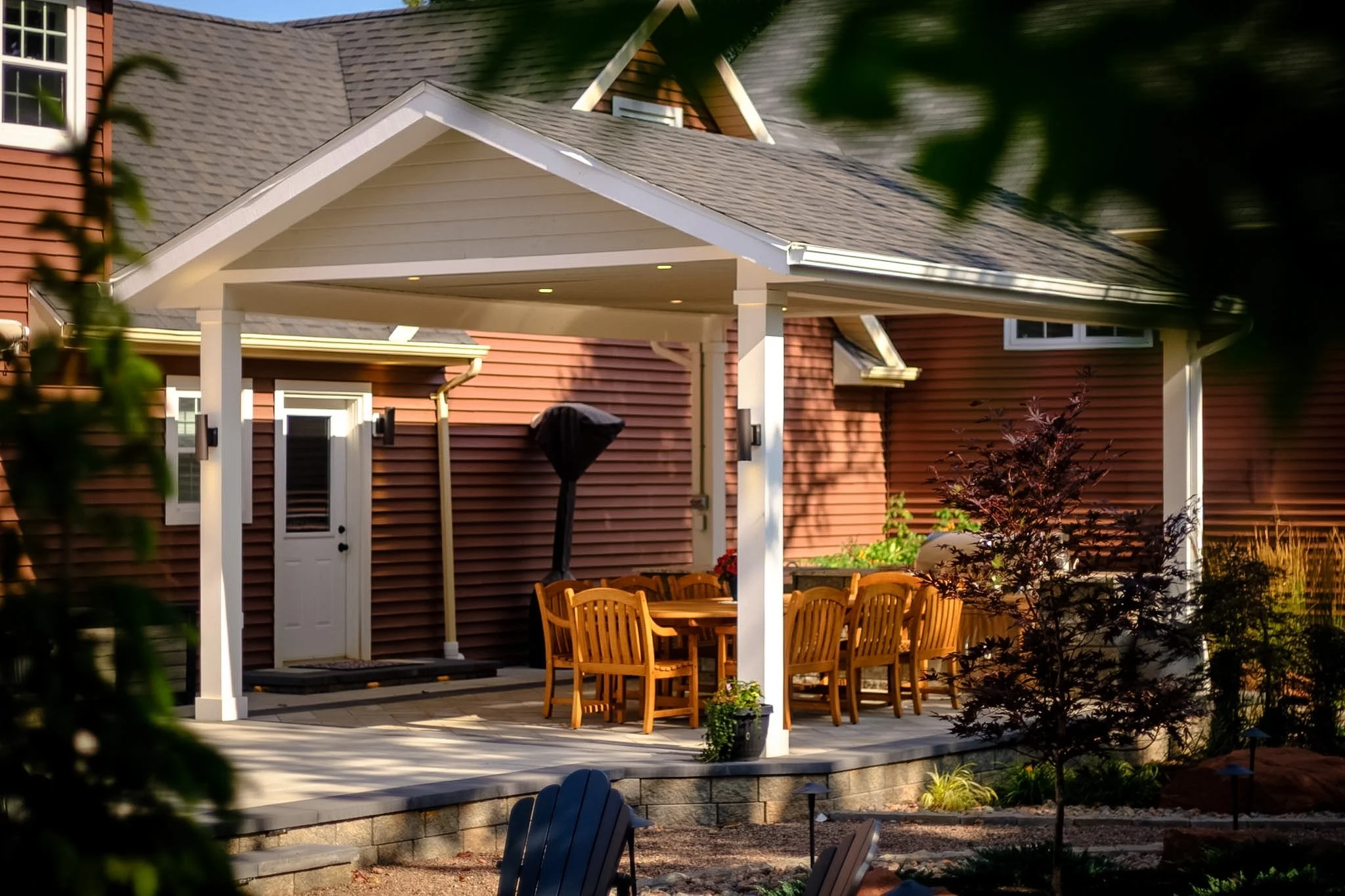 Classic outdoor gazebo gable roof with pot lights, outdoor dining area, and kitchen. 