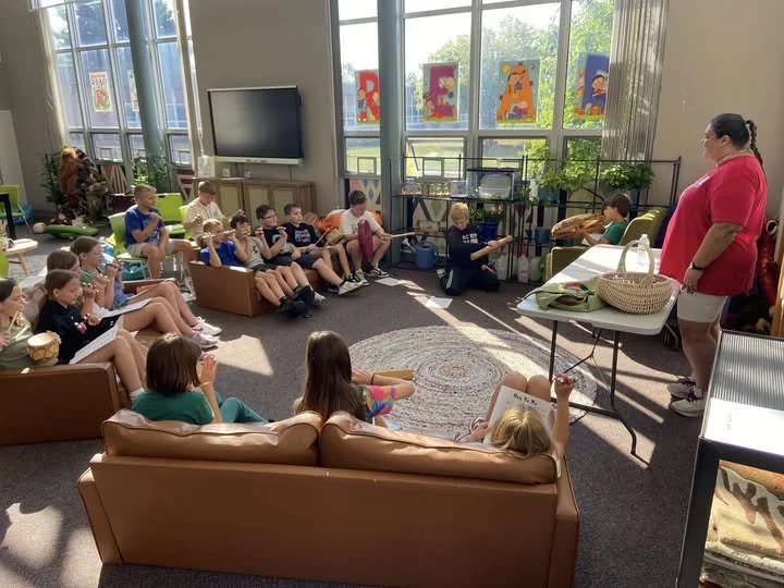 Quiet Souls Events and Education's CEO, Kim Sigafus, often visits schools to share the native culture. She is pictured here with students from Dakota Elementary.