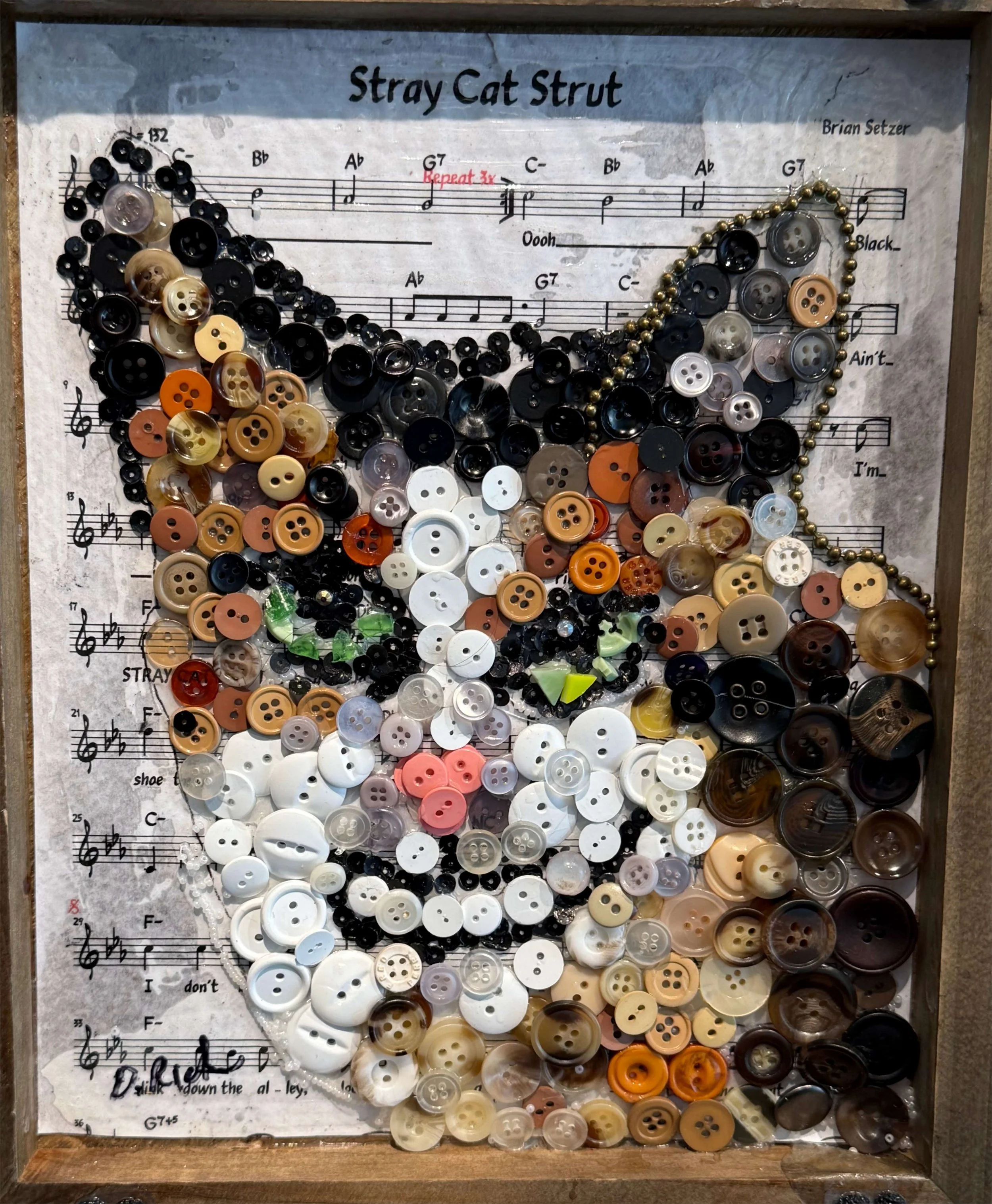 Button Cat on Sheet Music