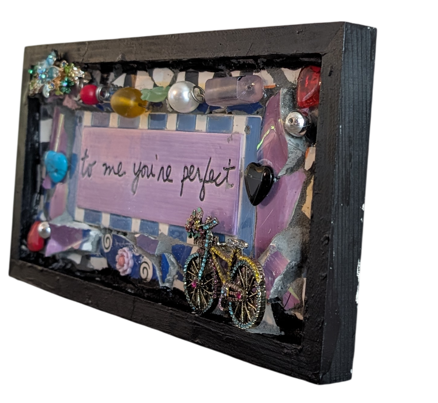 Right side view of To Me You're Perfect assemblage by Debra Rich showing bejeweled bicycle pin and layered mosaic construction