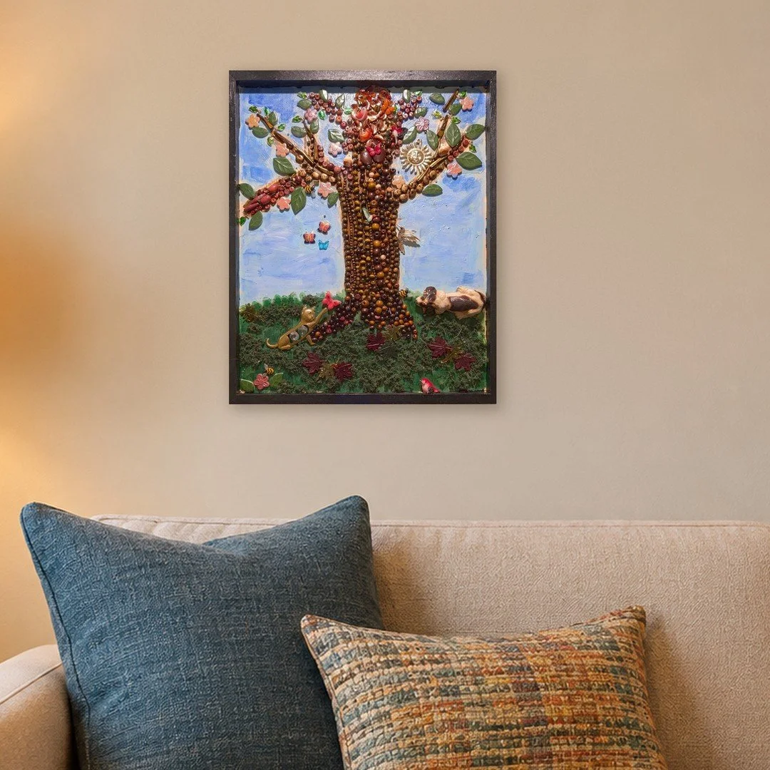 The Last Tree tree assemblage art, 20 by 16 inches, hanging above a beige sofa-zoomed