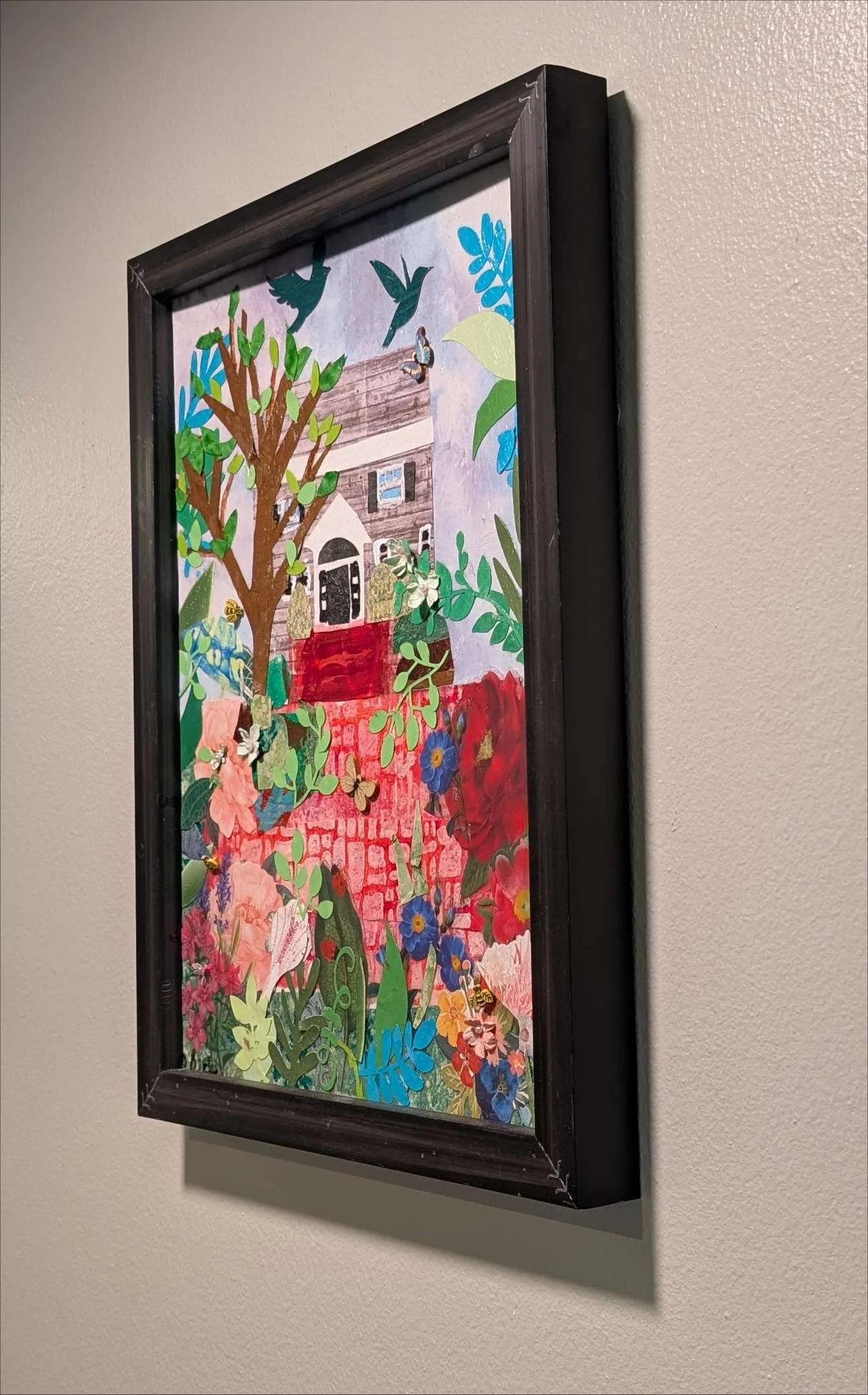Vibrant 13.5x17.5" handcrafted collage of a home surrounded by a garden by Sarasota Artist, Debra Rich-on-wall-right