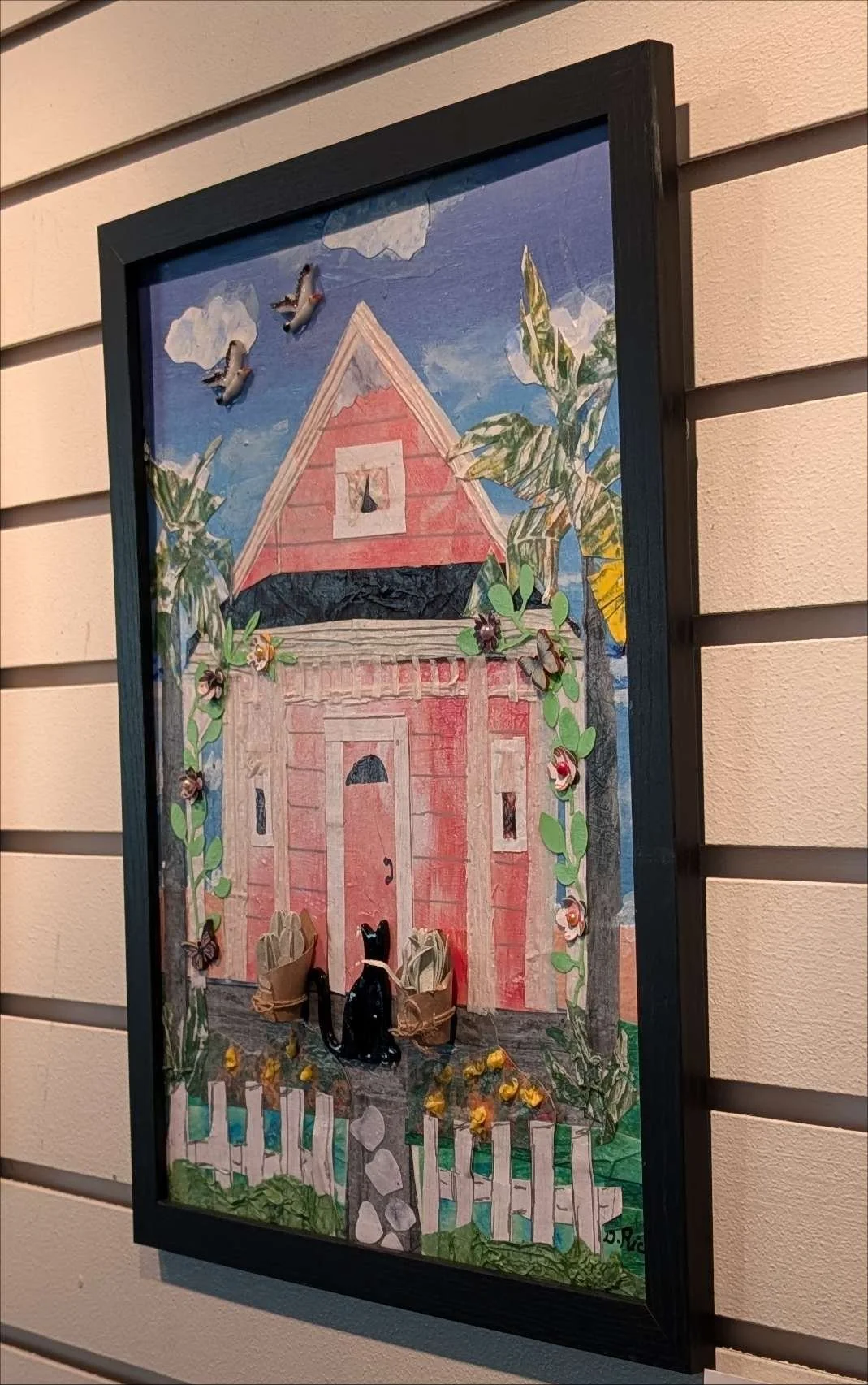 Handcrafted collage of a countryside scene with black cat, birds and lush vegetation in a rustic frame, by Sarasota Artist, Debra Rich - on a wall-right