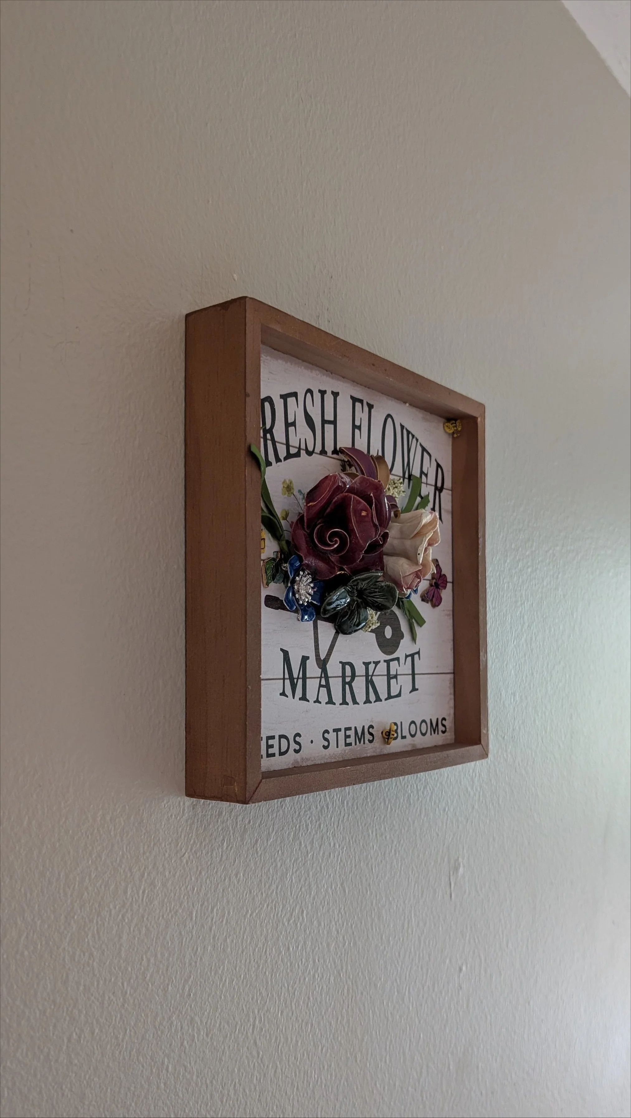 Left side view of Fresh Flower Market floral assemblage by Sarasota artist Debra Rich showing frame depth and sculptural ceramic flower construction