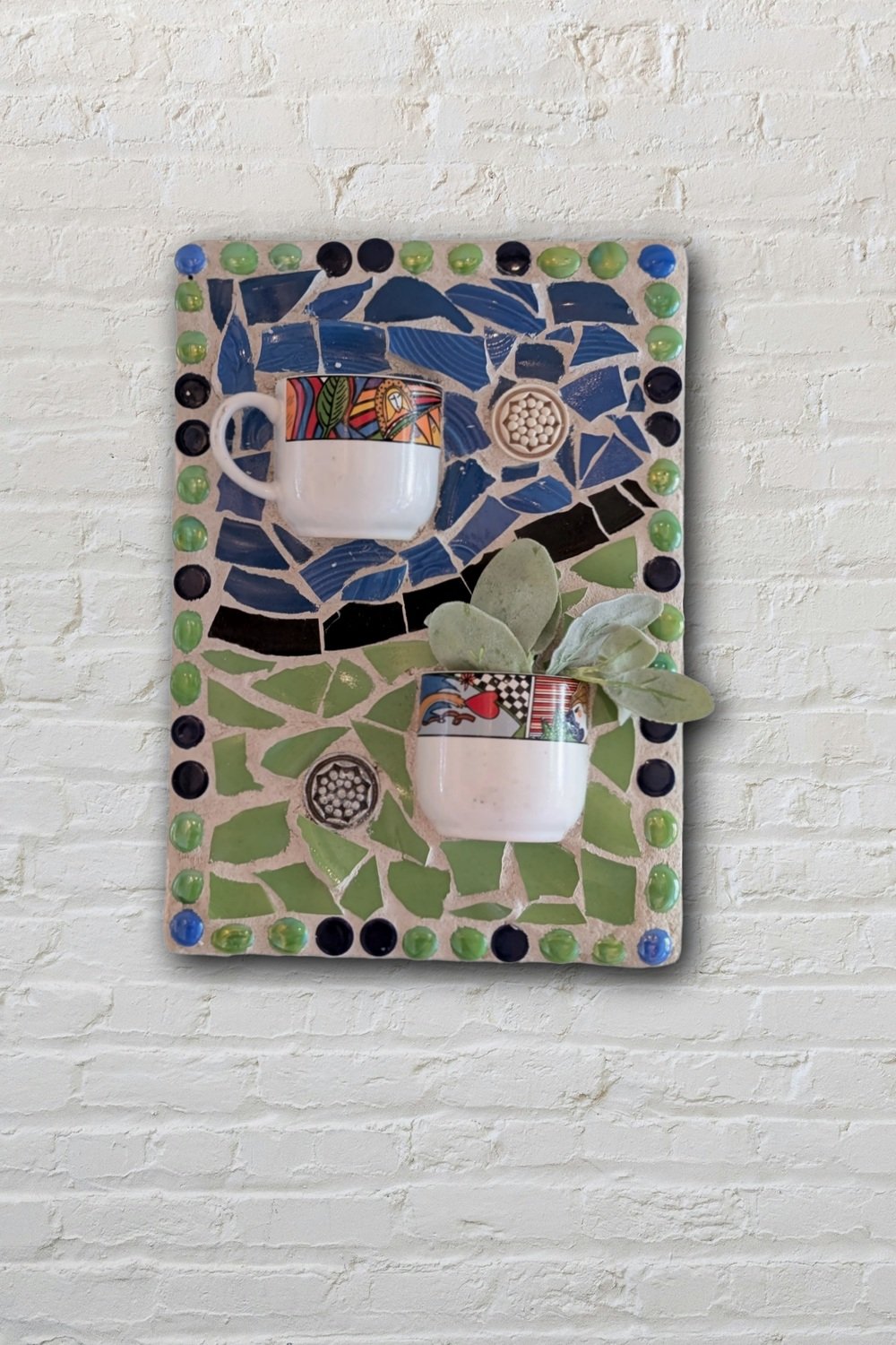 Two cups mosaic wall art with succulents on white brick — 3D handmade assemblage by Sarasota artist Debra Rich