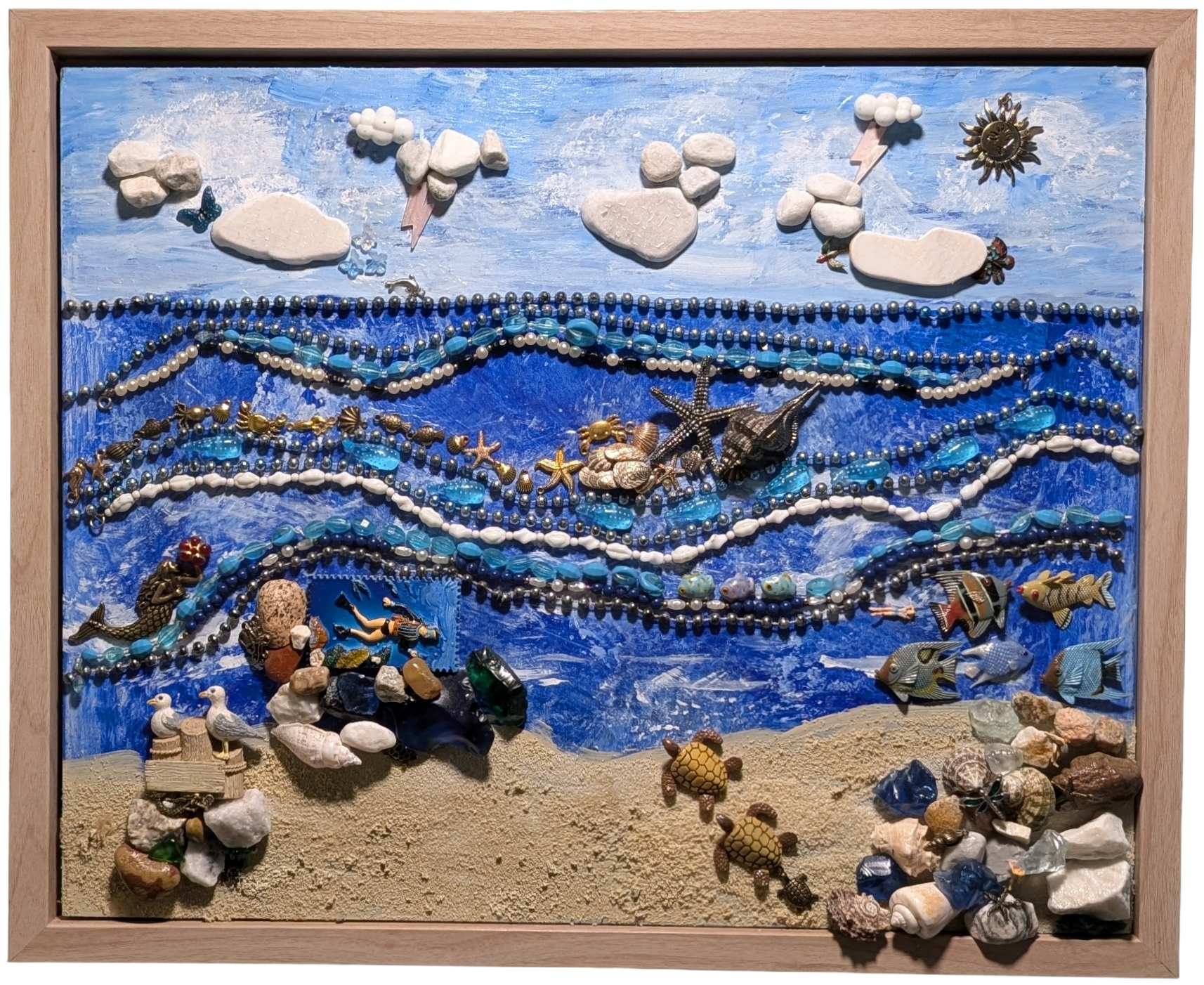 Handcrafted 22x18 inch beach assemblage made with natural shells, stones, and beads in a seaside scene