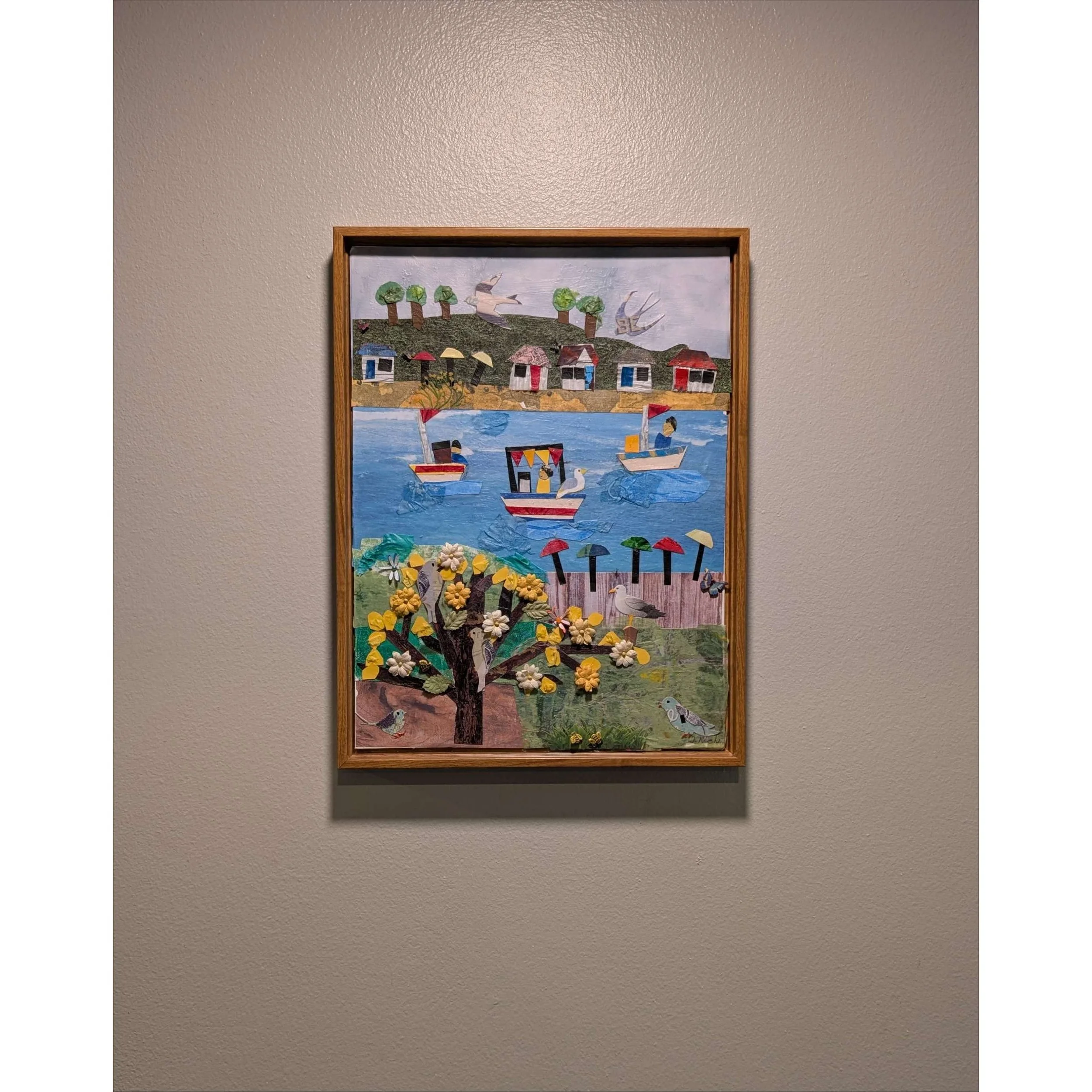 Sailing with Friends Collage Wall Art mounted on a wall, highlighting its modern wooden frame and layout.