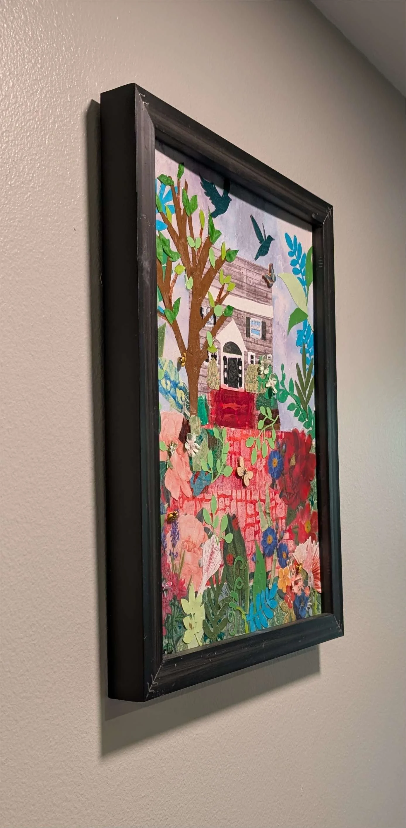 Vibrant 13.5x17.5" handcrafted collage of a home surrounded by a garden by Sarasota Artist, Debra Rich-on-wall-left
