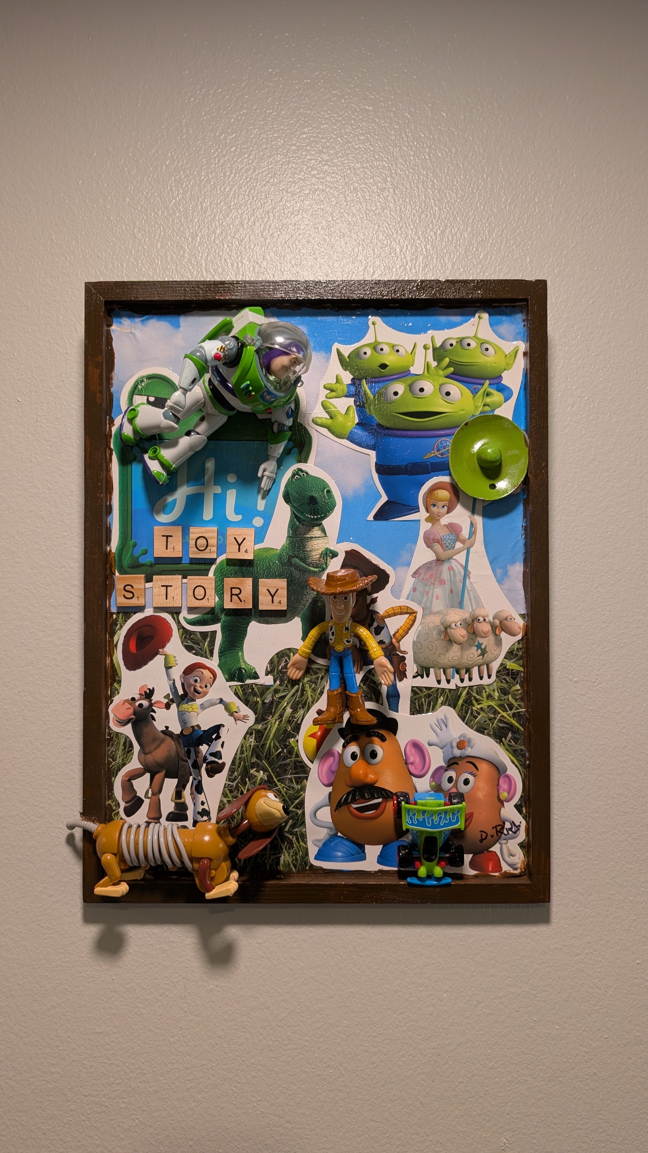 Toy Story mixed-media assemblage art with Buzz Lightyear, Woody, and Rex figures by Debra Rich-on wall
