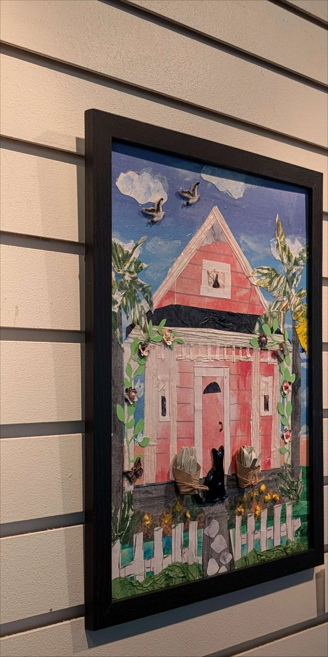 Handcrafted collage of a countryside scene with black cat, birds and lush vegetation in a rustic frame, by Sarasota Artist, Debra Rich - on a wall-left