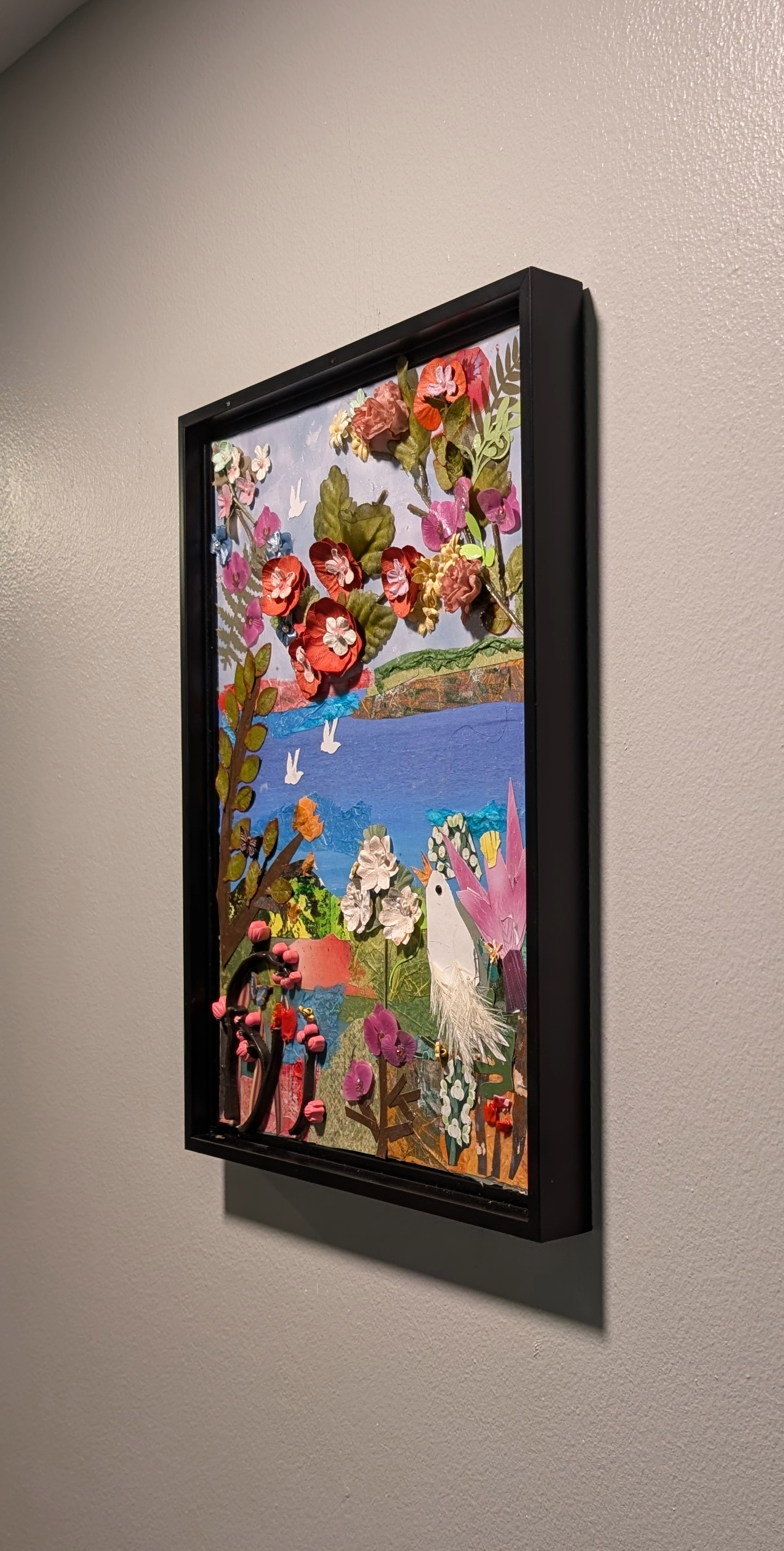 Textured mixed-media collage depicting a vibrant landscape with bright 3D paper flowers, water, & flying white birds -right side, by Sarasota Artist Debra Rich.