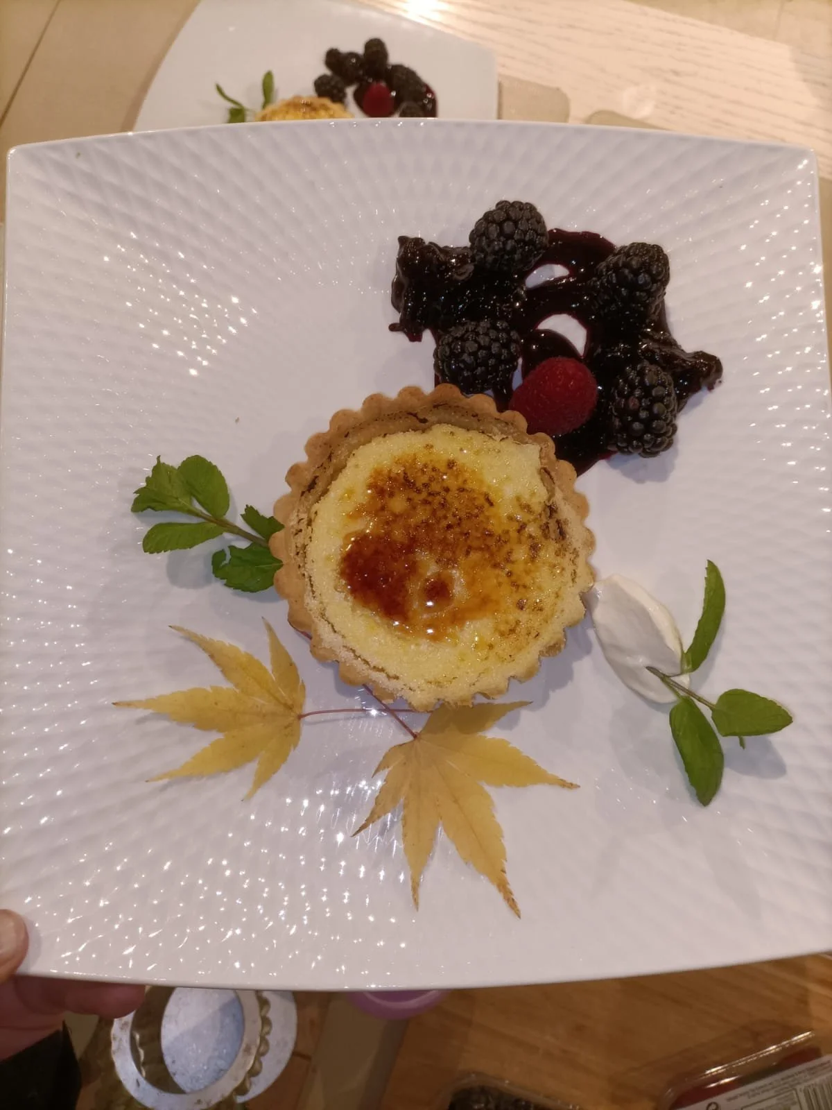 Bruleed tart au citron with creme fraiche or cream and berry compote