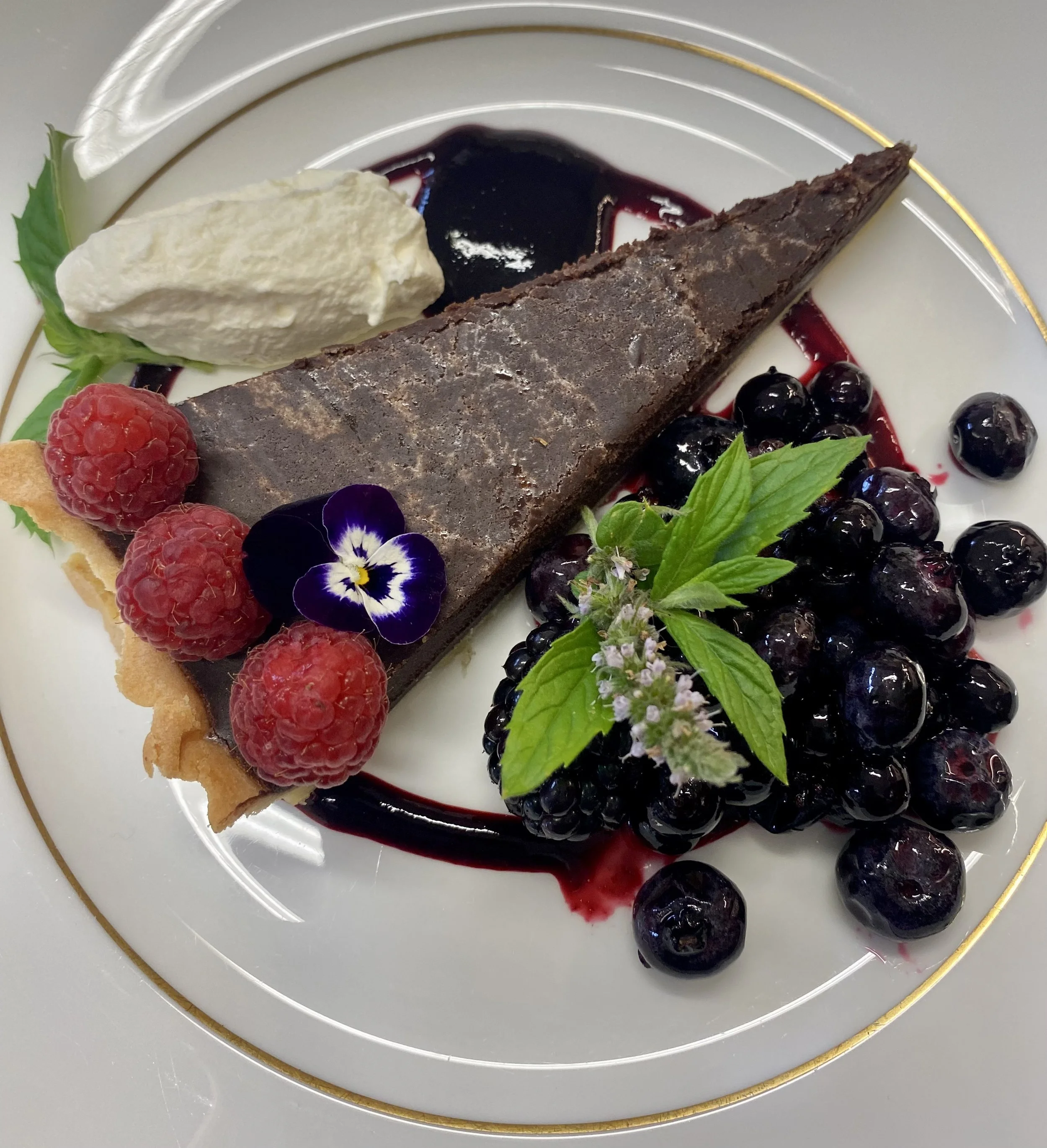 Rich chocolate tart with dark berry compote