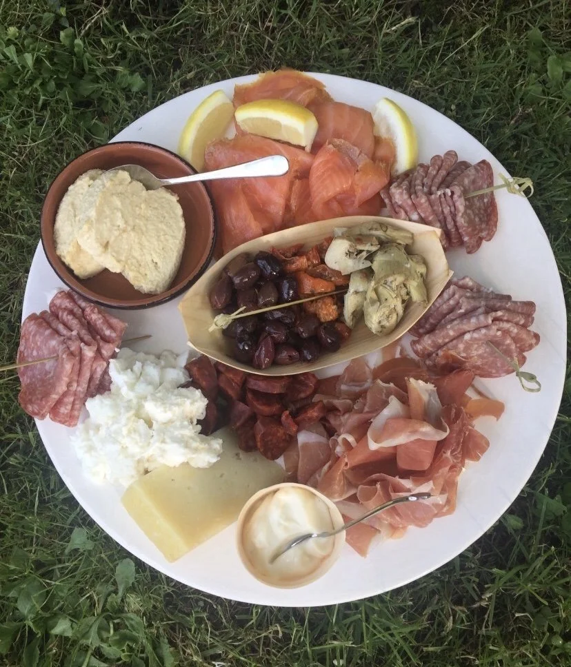 Anti pasta platters with a variety of cured meats, olives, hummus and semi sun-dried tomatoes 
