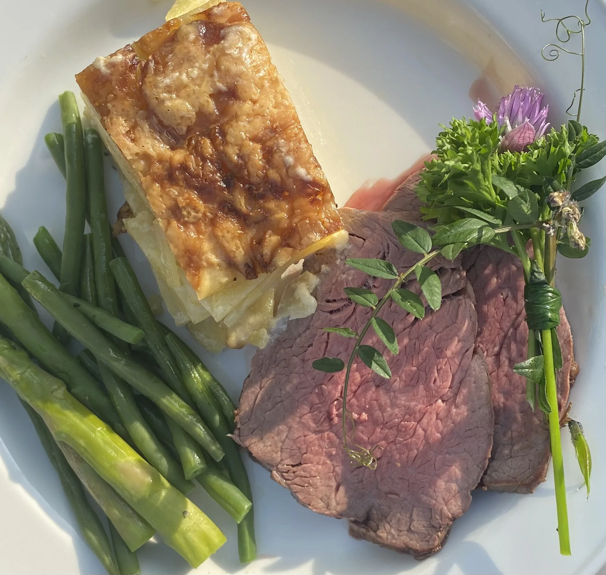 Rare fillet of beef with potato dauphinoise and fresh greens