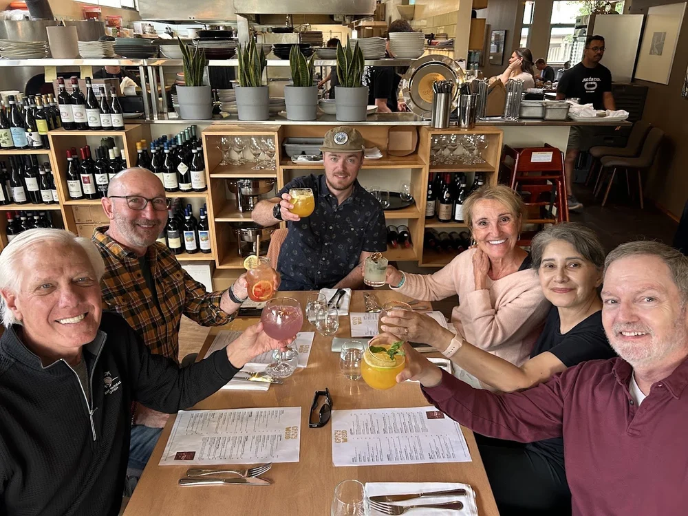 A Columbia Wild Guides group raising a toast over dinner at Crazyweed restaurant in Canmore