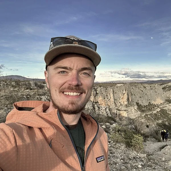Jacob Downie, founder of Columbia Wild Guides, smiling on a mountain trail