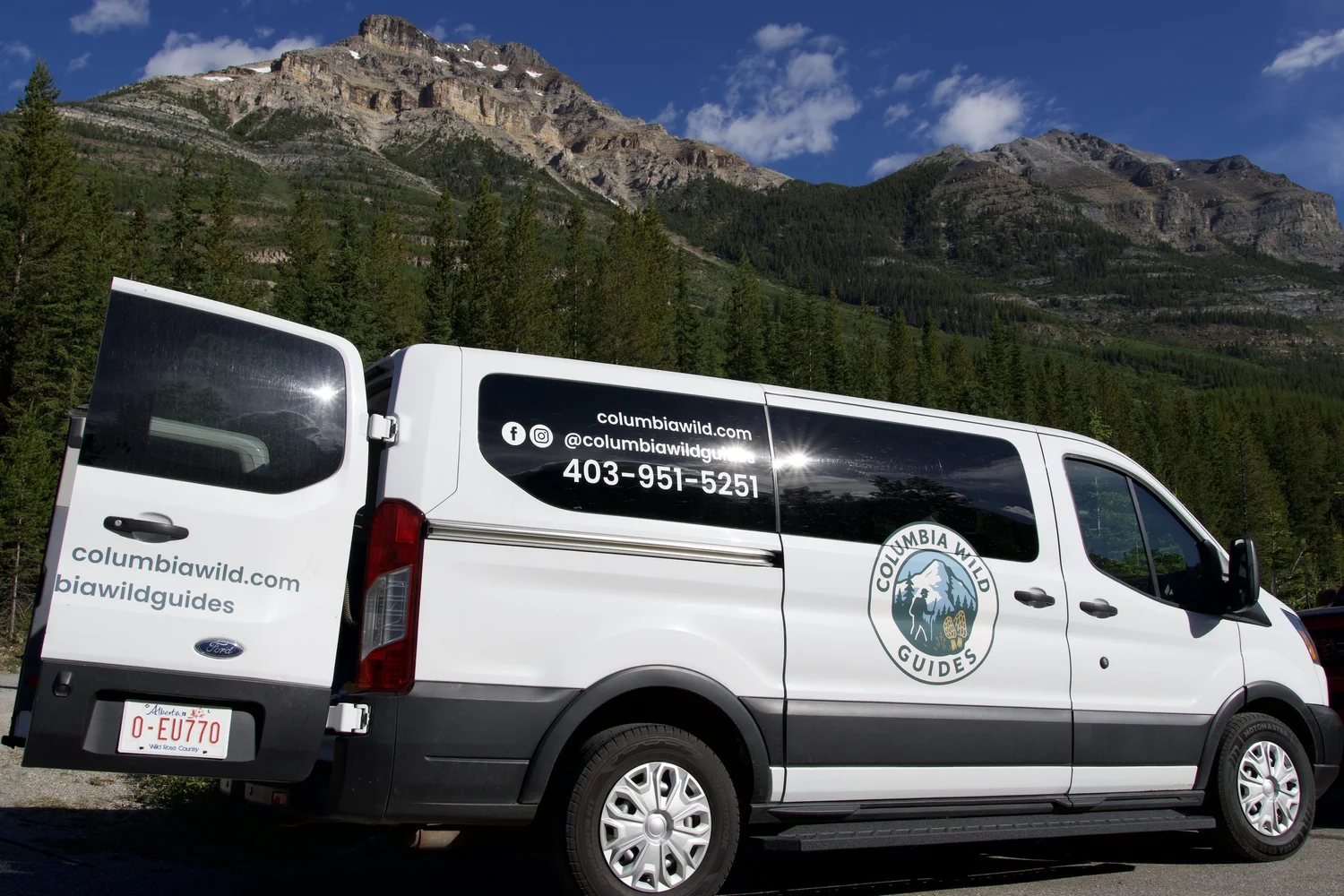 Private Calgary Airport to Banff transfer van below a Rocky Mountain peak in Banff National Park