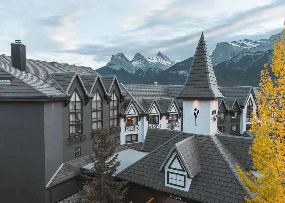 Everwild Canmore hotel with the Three Sisters peaks behind it, Canmore, Alberta