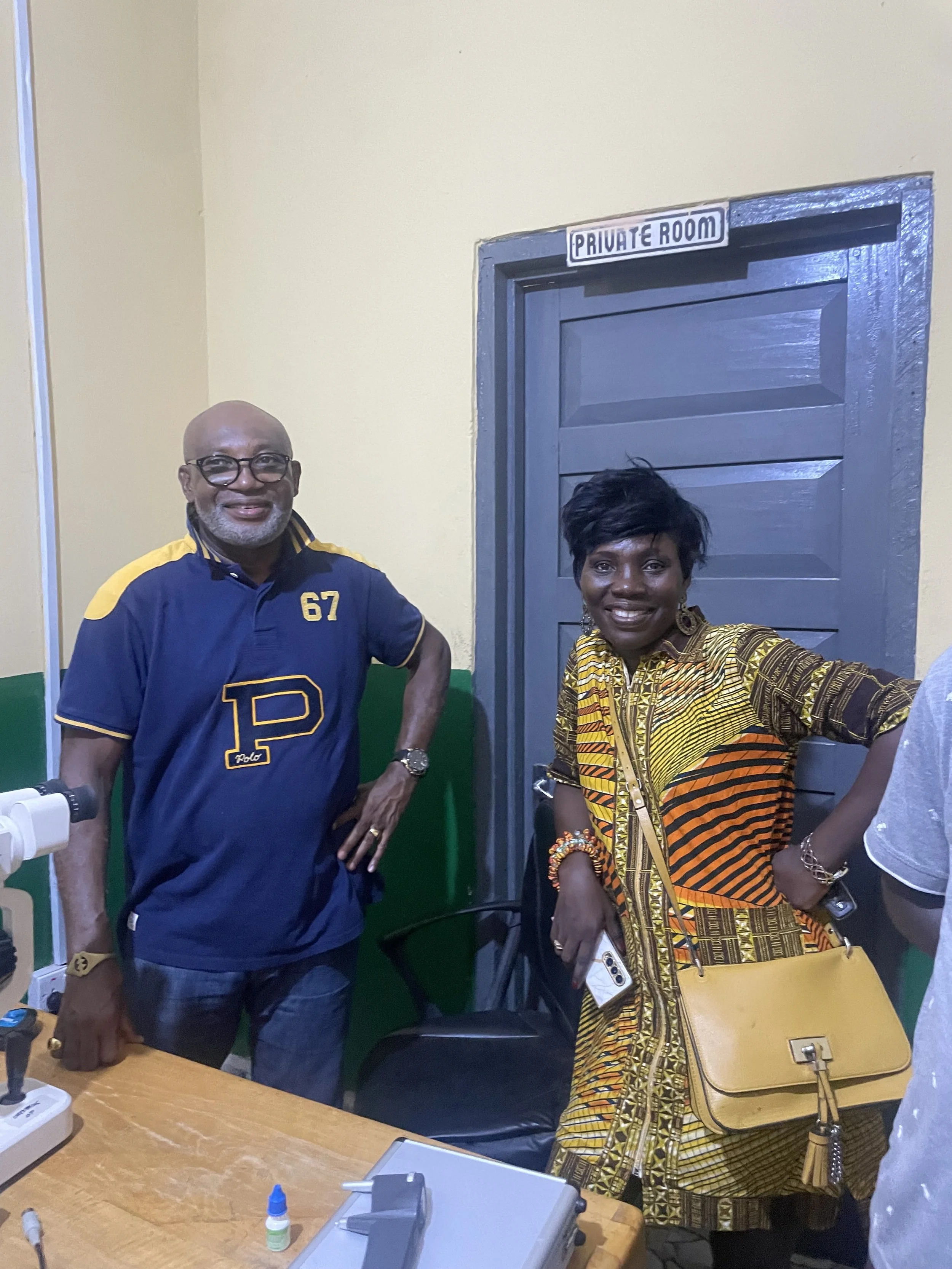 Two people standing in a room labeled 'Private Room' with a microscope on a table.