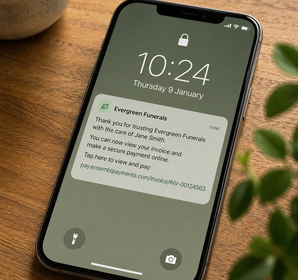 Smartphone on wooden table displaying a notification from Evergreen Funerals about viewing and paying an invoice, with a lock icon at the top, and icons for flashlight and camera at the bottom.