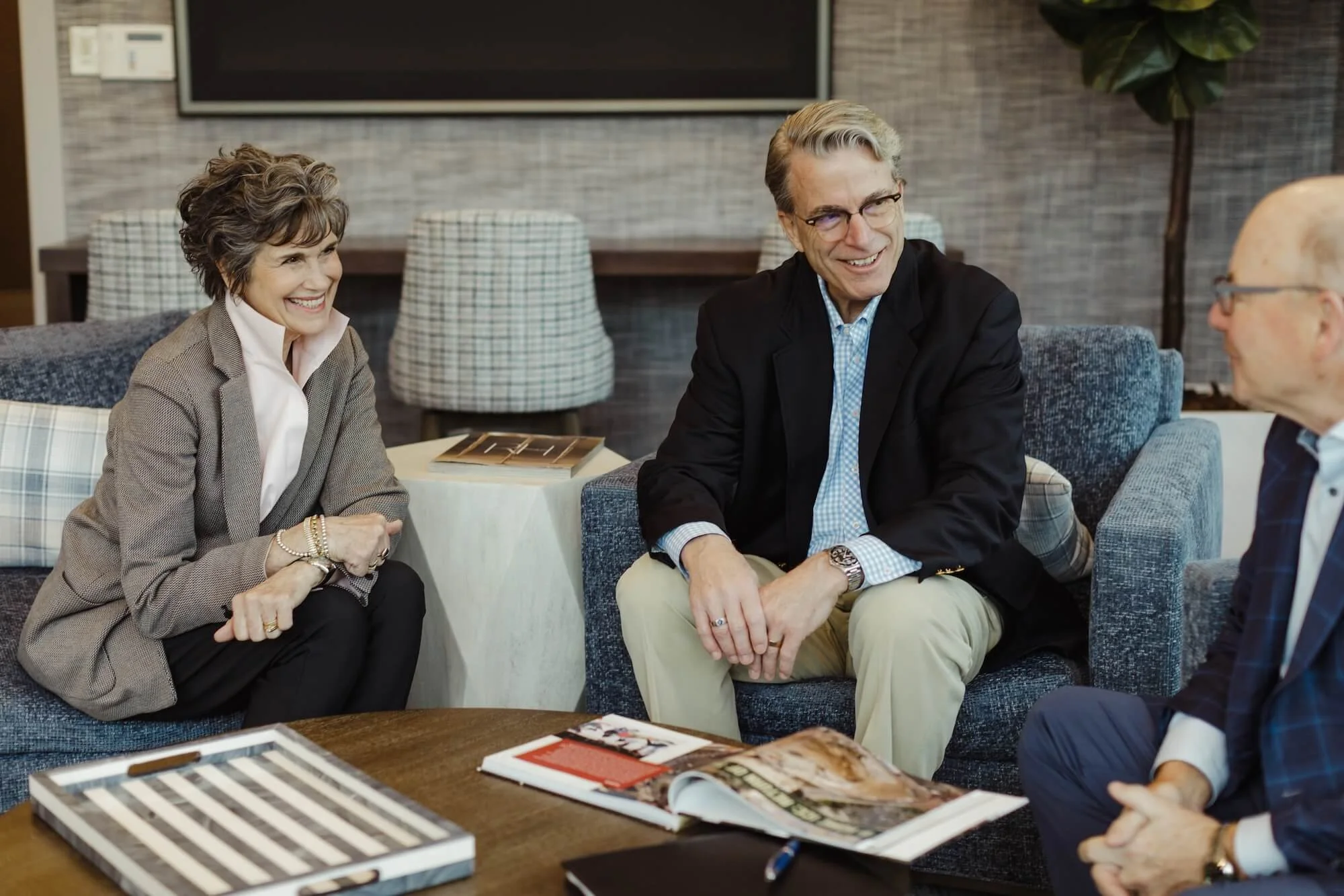 Bill Boer meets with a smiling couple, seeking advisory services.