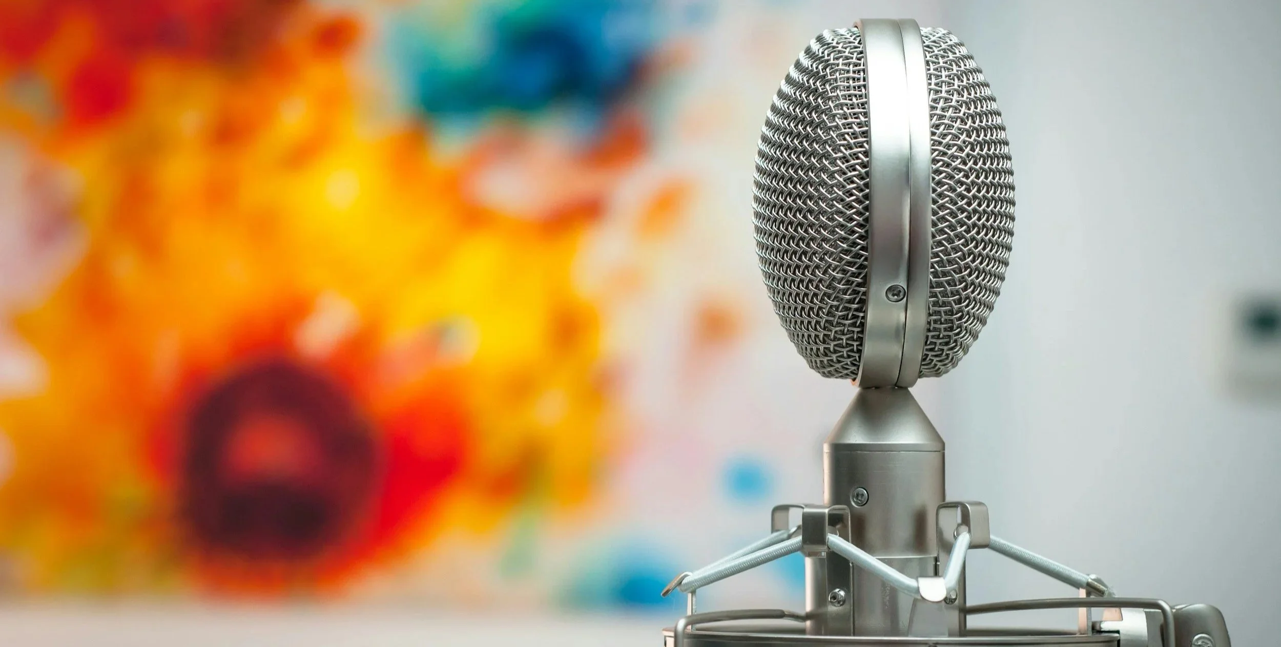 Close-up of microphone representing media interviews and press coverage for Exploration Theatre, LLC.