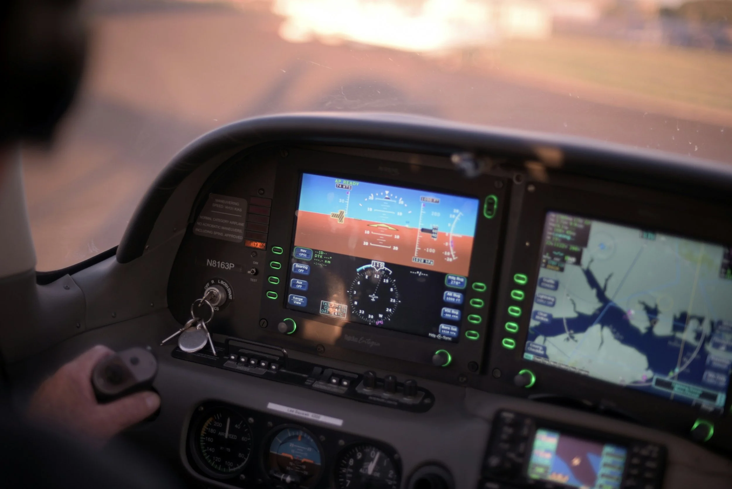 The cockpit of an aircraft showing flight instruments and navigation screens during flight.