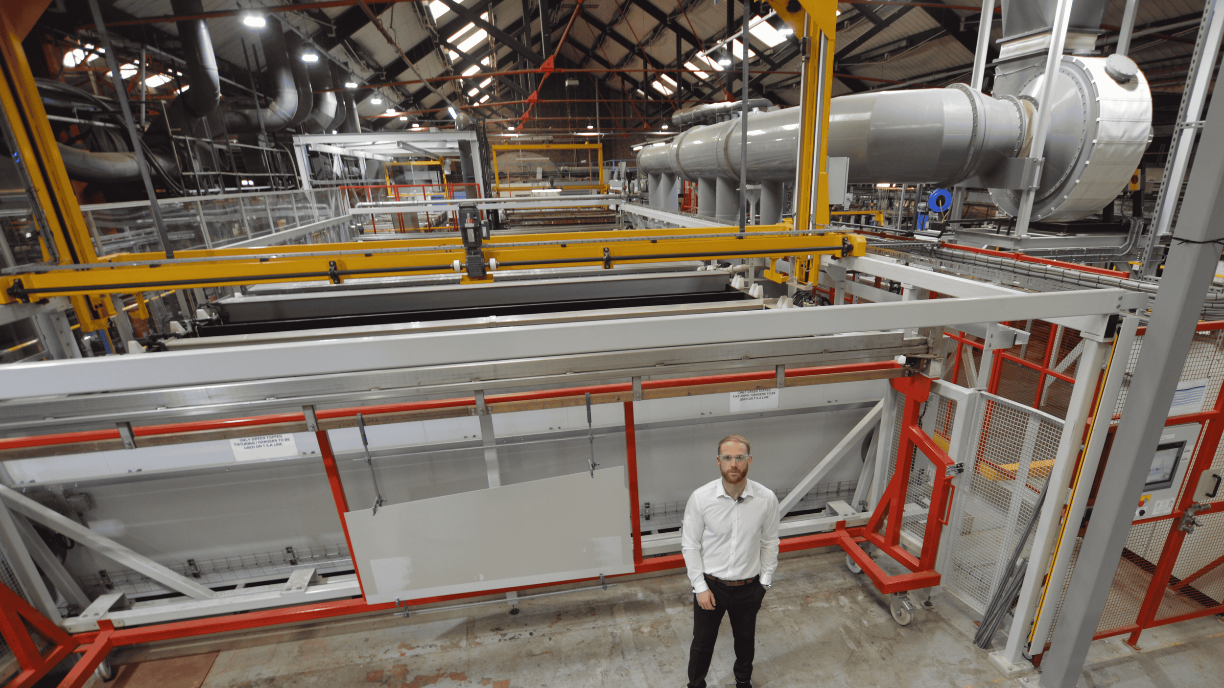 ASG Team Member in Front of Machinery