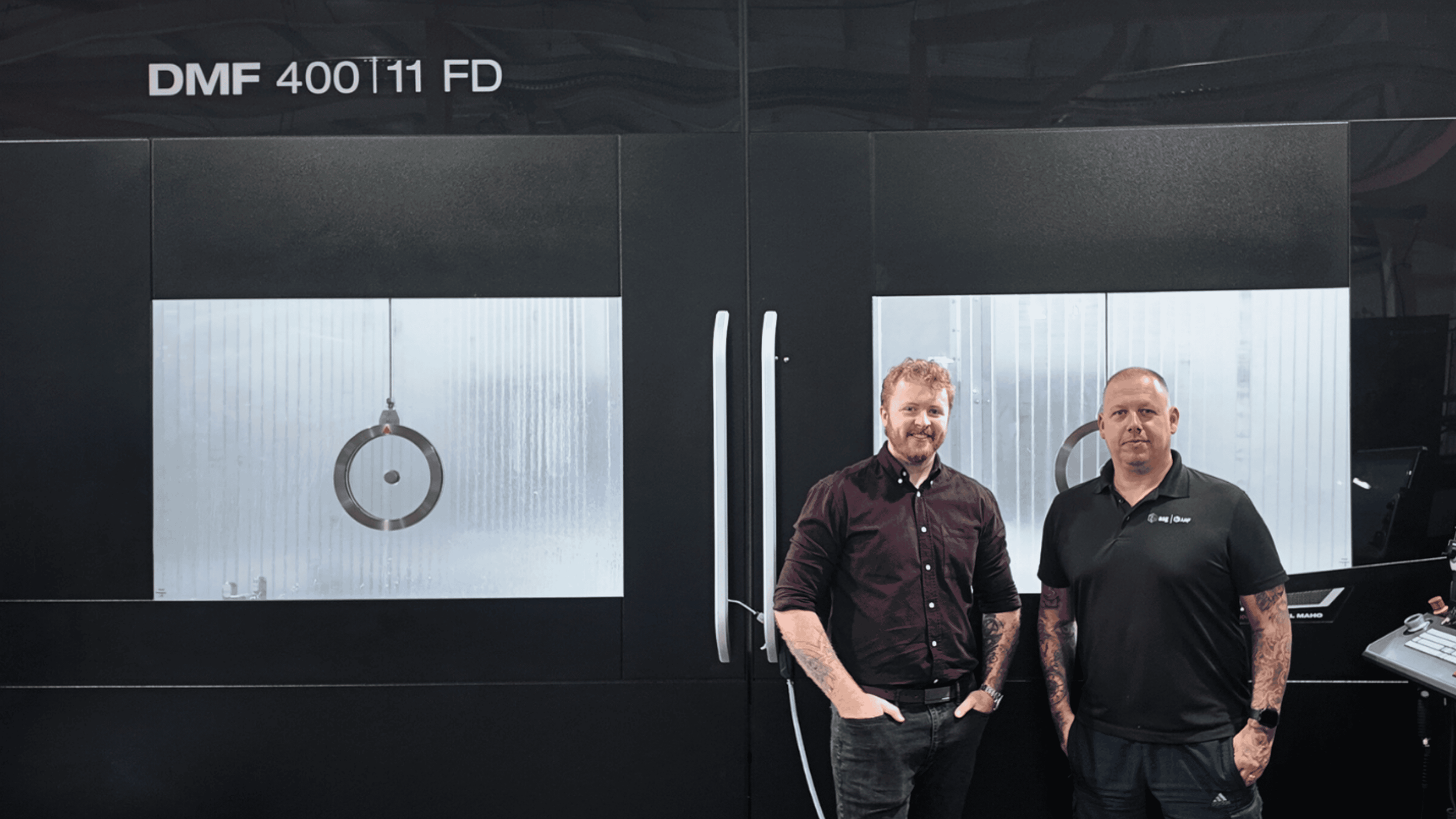 ASG team members in front of the new DMF 400 11 FD machinery