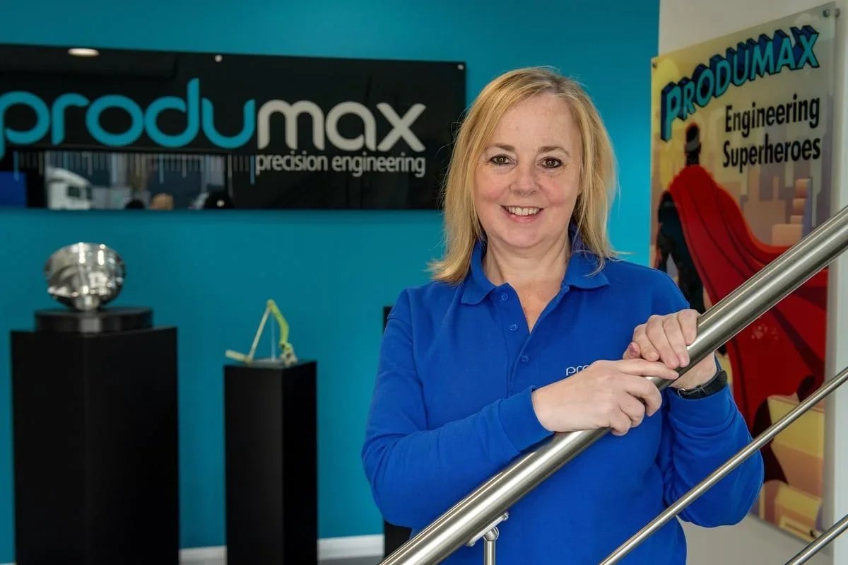 Group Director Mandy Ridyard posed in front of signage