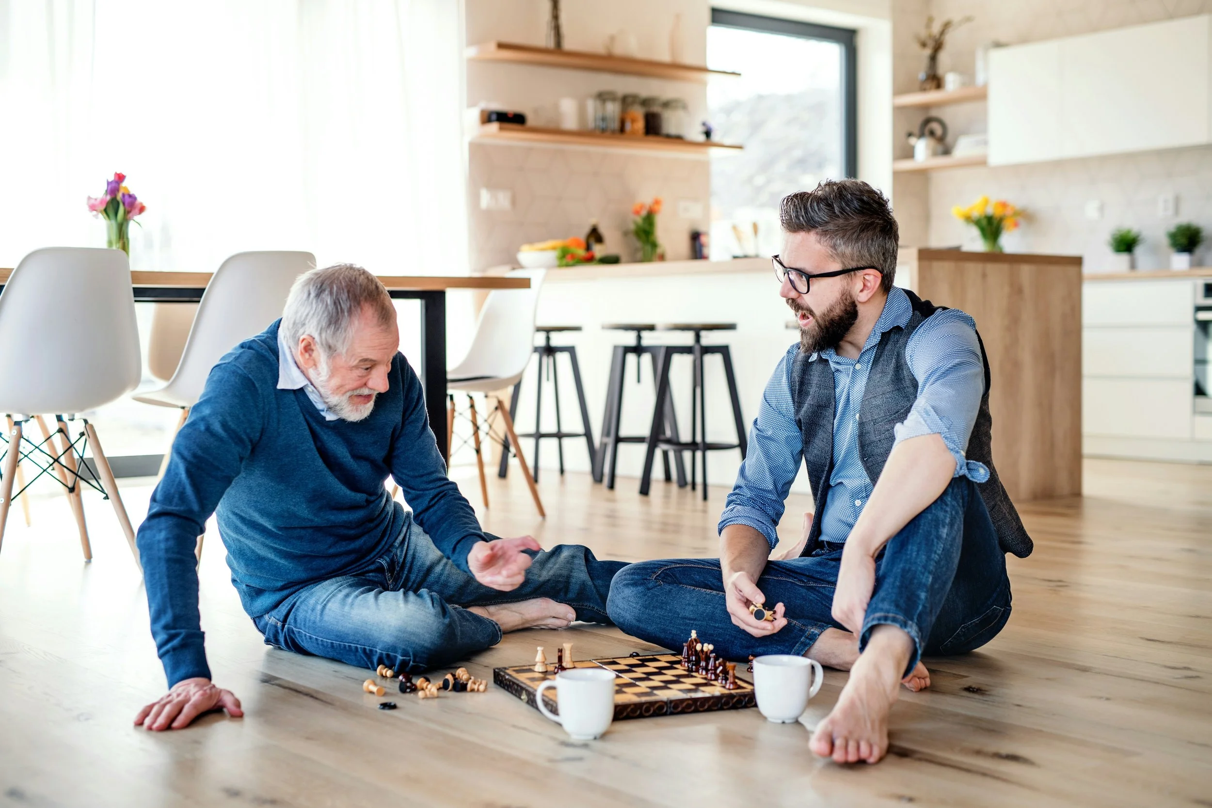 Two men of different ages playing a game together on the a wood floor