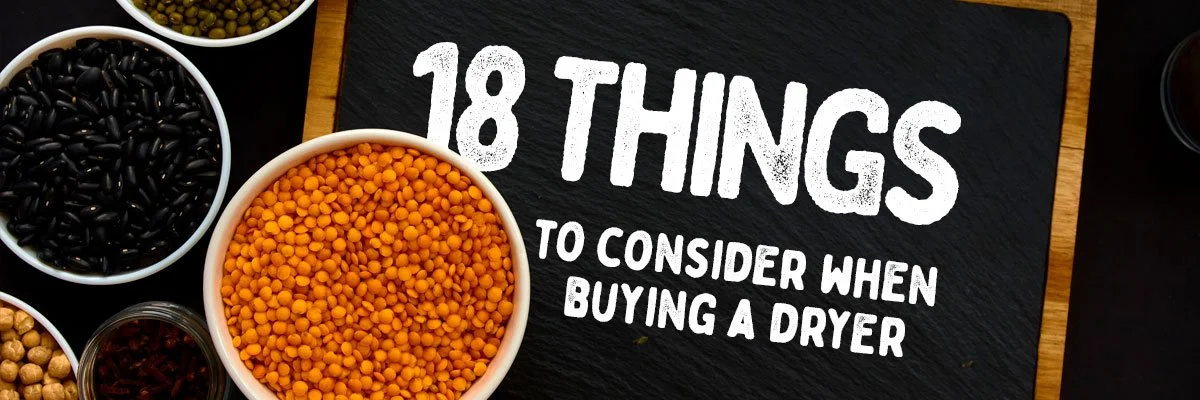 Bowls of seeds and beans surrounding a sign listing 18 considerations when buying a dryer.