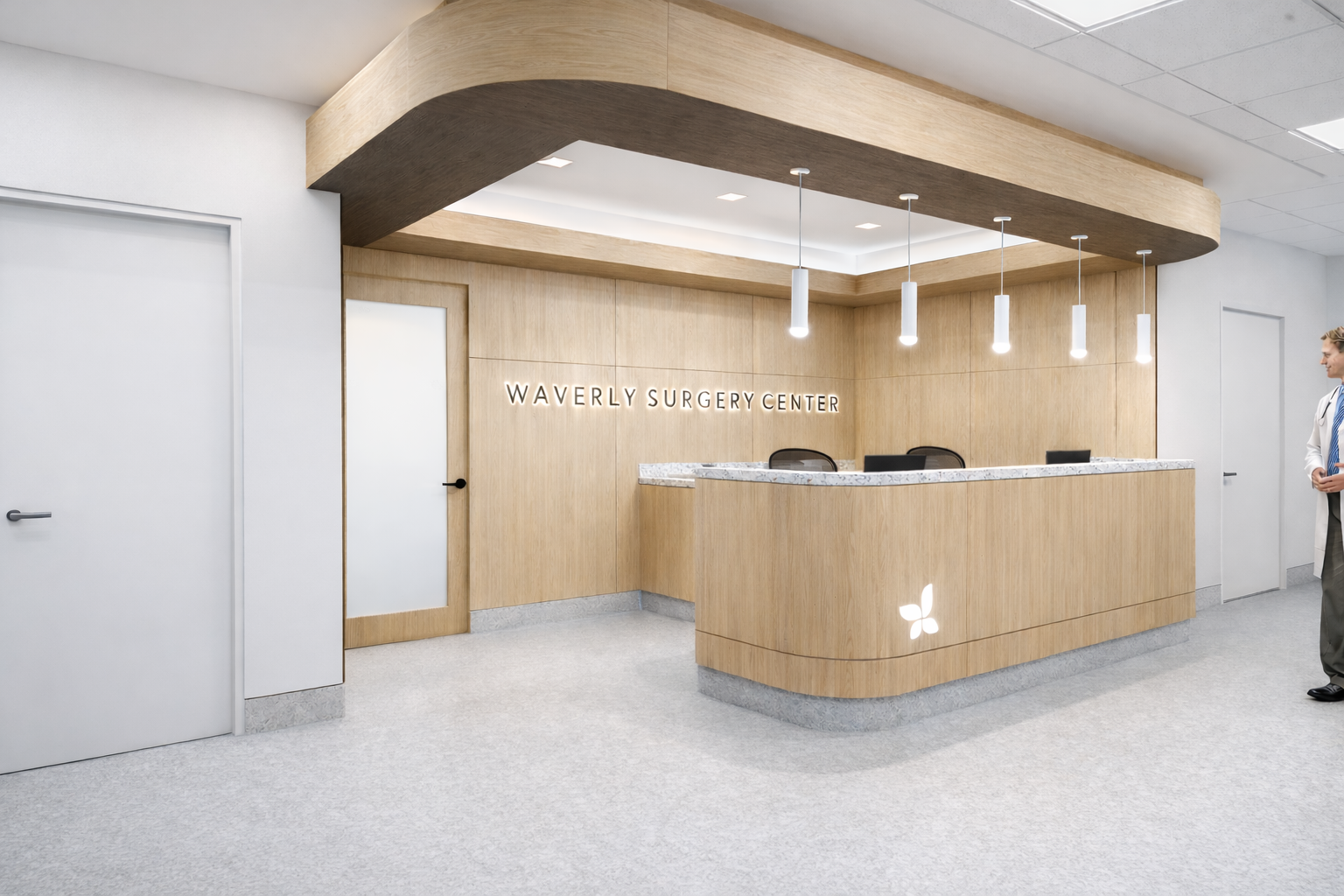 A white oak nurses station with curved desk and wood paneled accent wall within a surgery center.