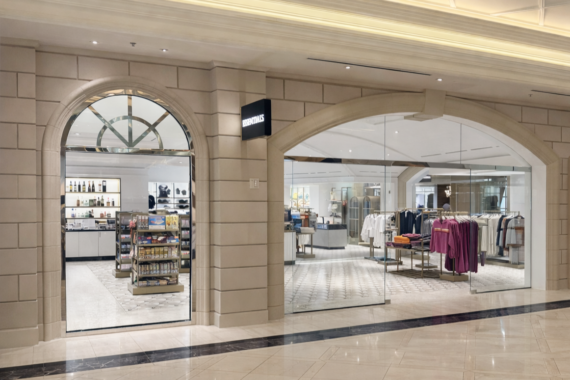 A stone clad mall retail storefront with black balde sign