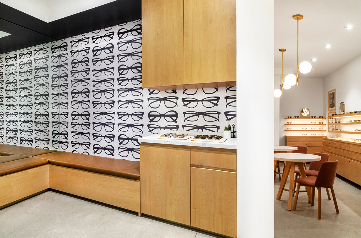 Whimsical environmental graphics in the waiting nook at a modern optometrist office.