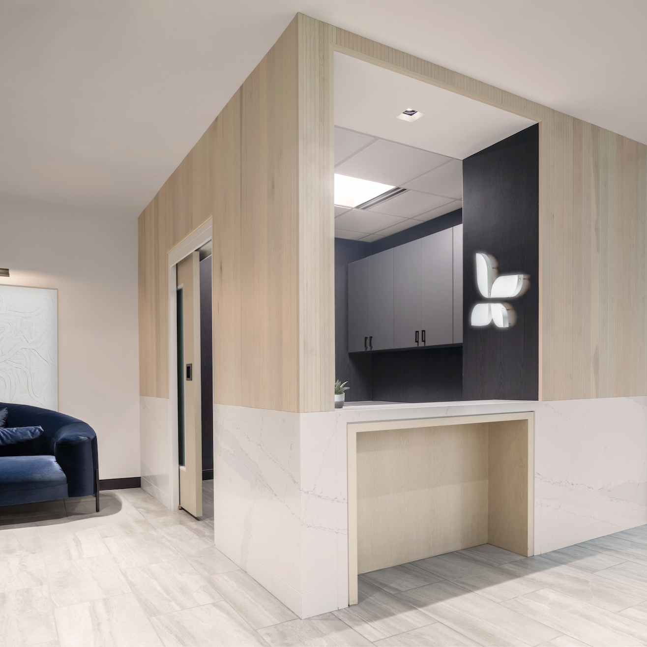A carrara marble and white oak tambour reception check-in room.