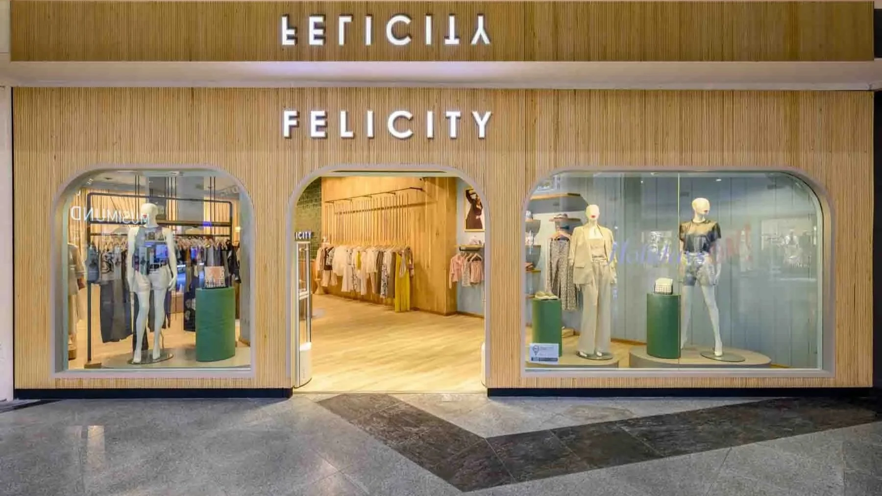 A wooden storefornt with an arched entrance and windows