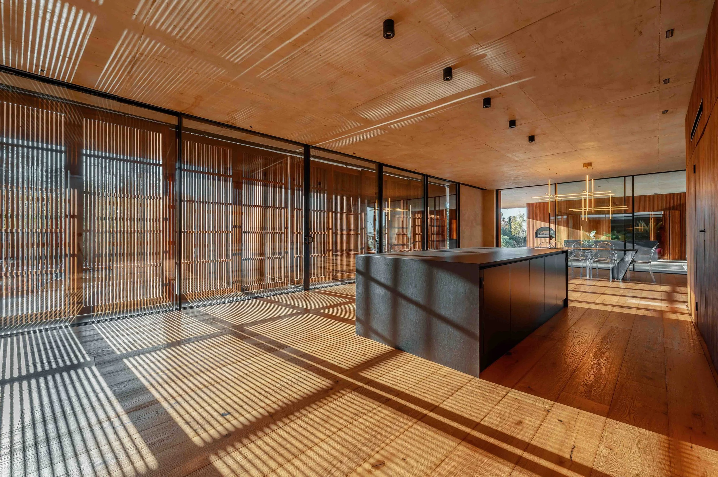 Modern minimalistic kitchen with geometric shadows and sunlight.