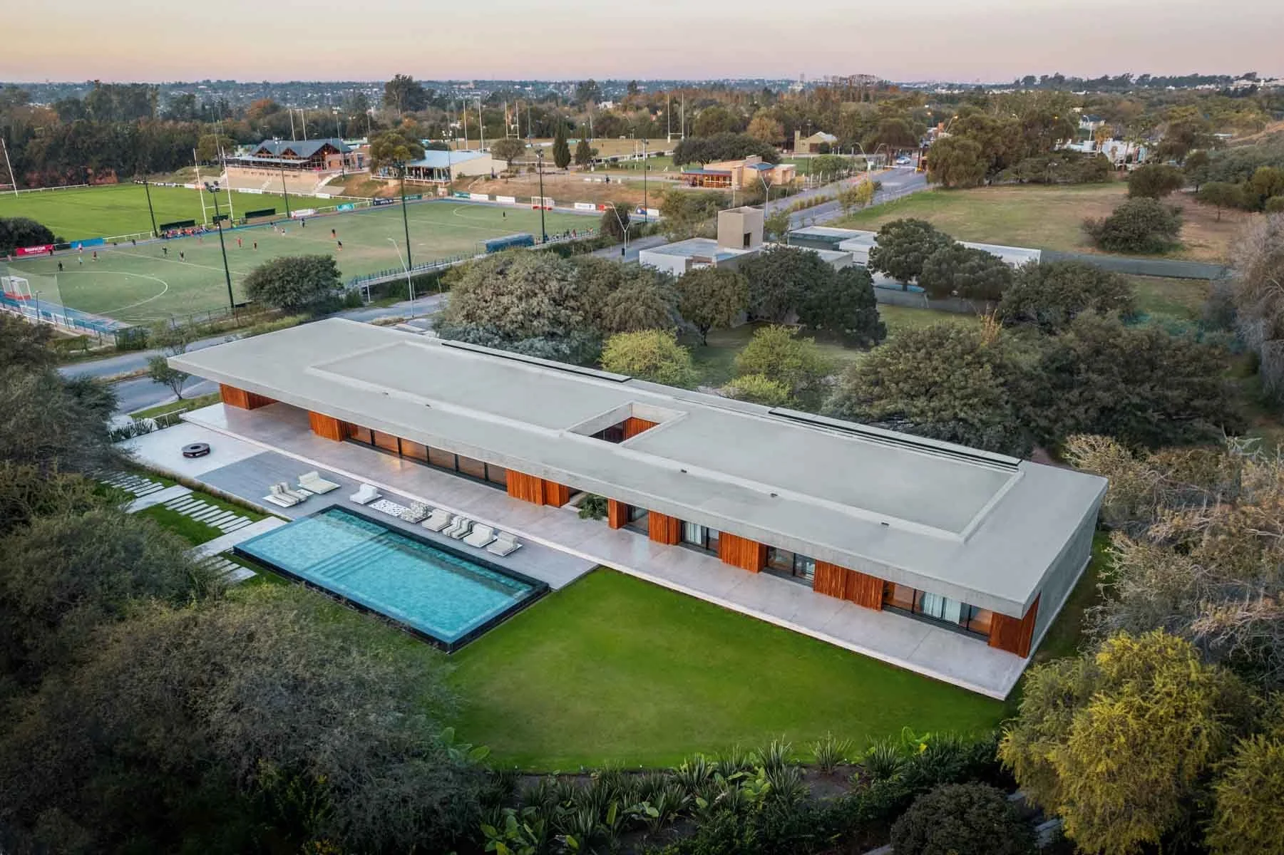 A bird's eye view of a modern home and swiming pool