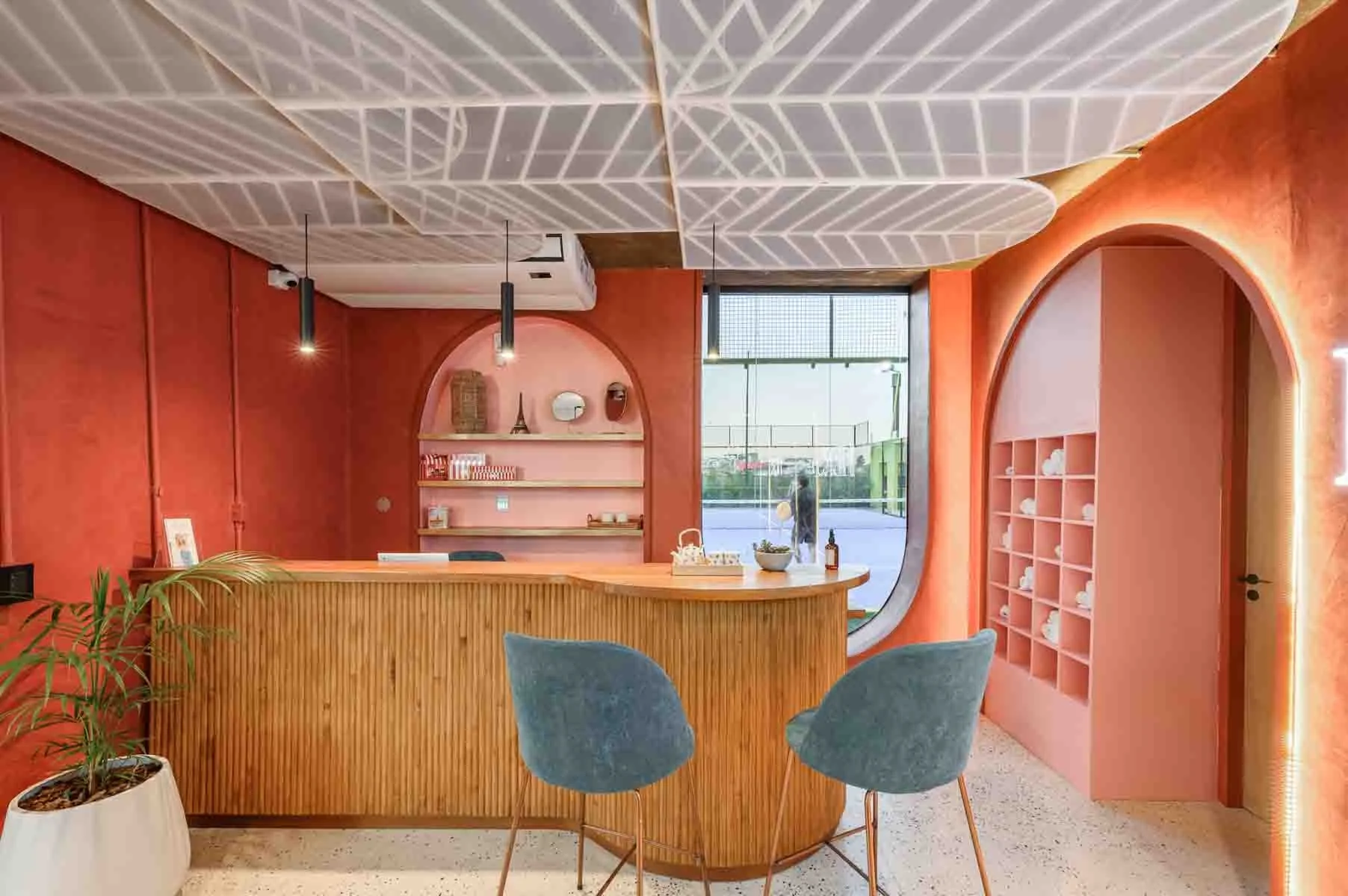 A tambour reception desk with arched shelving at a Med Spa
