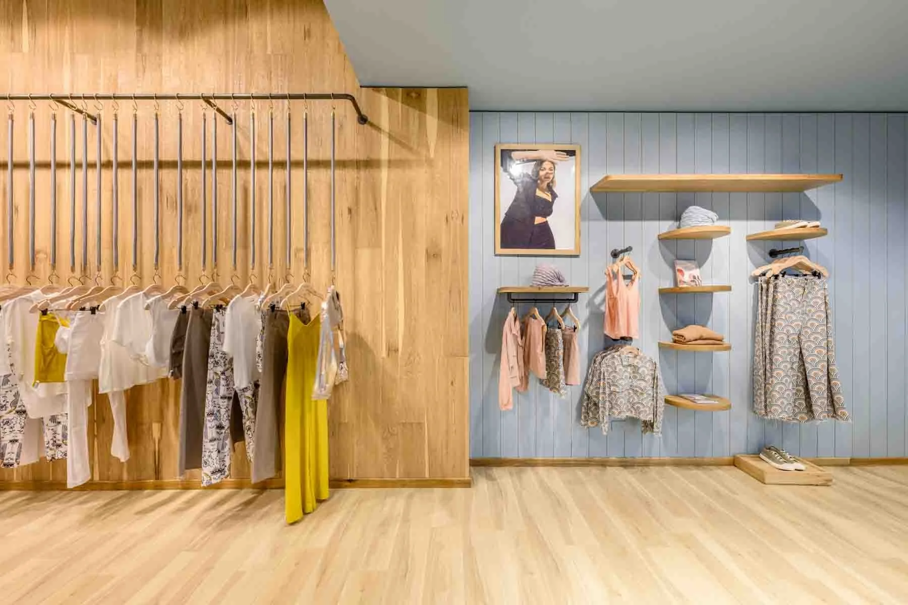 Wooden accent wall in reatil store with suspended clothing