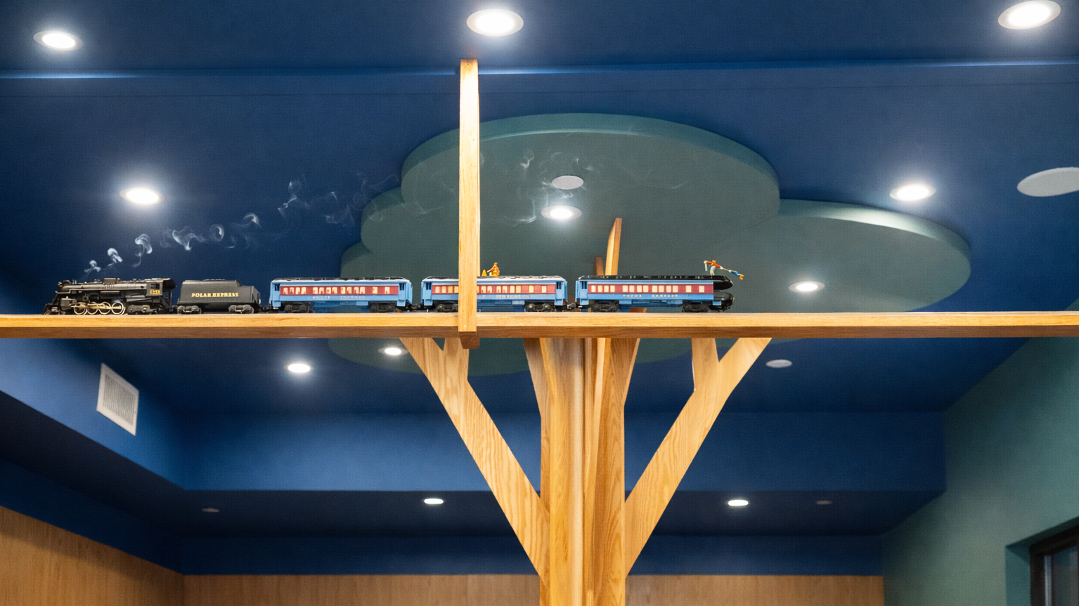 Custom millwork and a working model train in a kids retail store